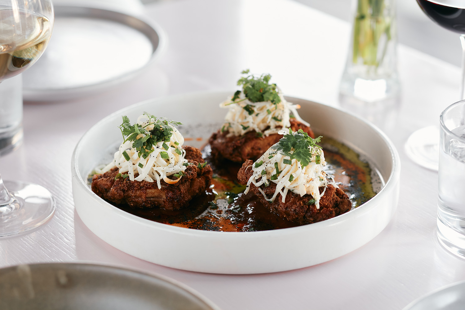 The buttermilk fried chicken with BBQ sauce, celeriac remoulade and leek ash. Photo / Babiche Martens