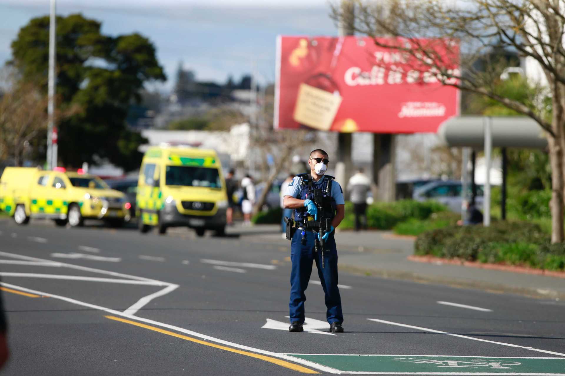 An armed police officer stands guard outside LynnMall last Friday. Photo / NZ Herald
