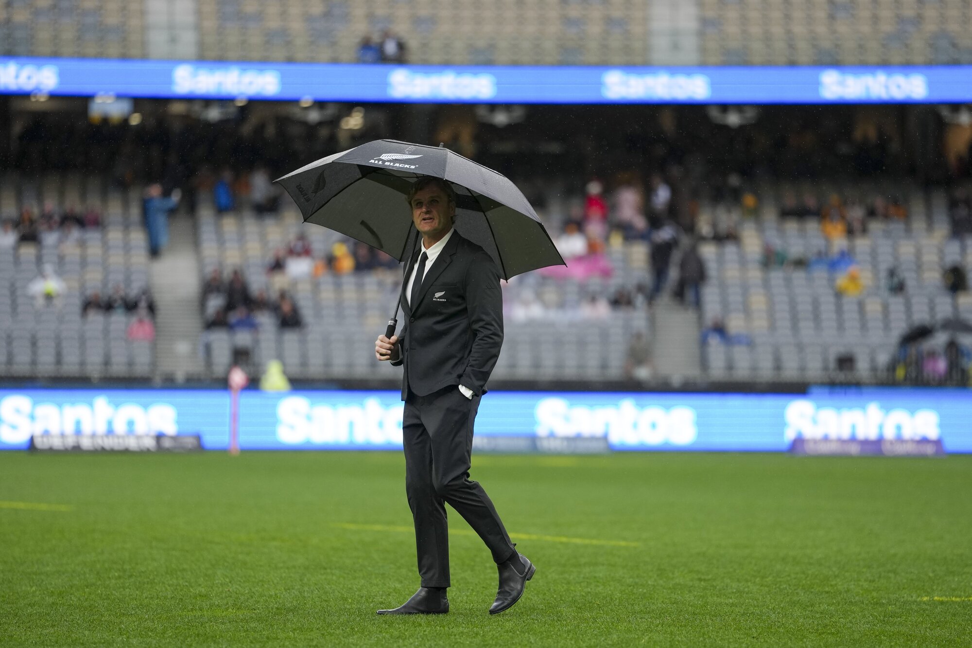 Scott Robertson shelters form the rain ahead of this year's Bledisloe Cup test against Australia, in Perth. Photo / SmartFrame