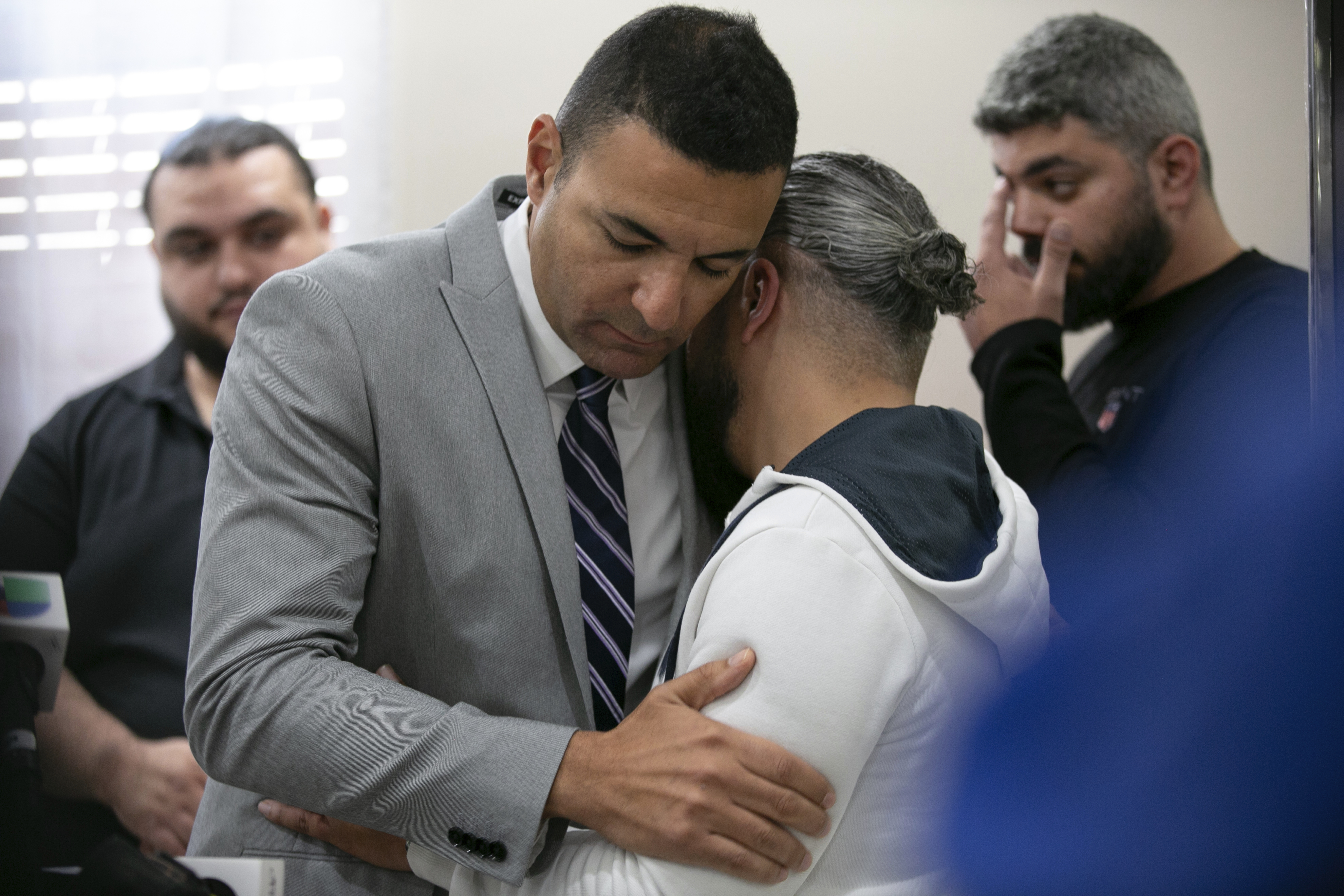 Ahmed Rehab (left), executive director of the Chicago chapter of the Council on American-Islamic Relations, embraces Odey Al-Fayoume, father of Wadea Al-Fayoume, 6, at a news conference at the Muslim Community Center on Chicago's northwest side. Photo / AP