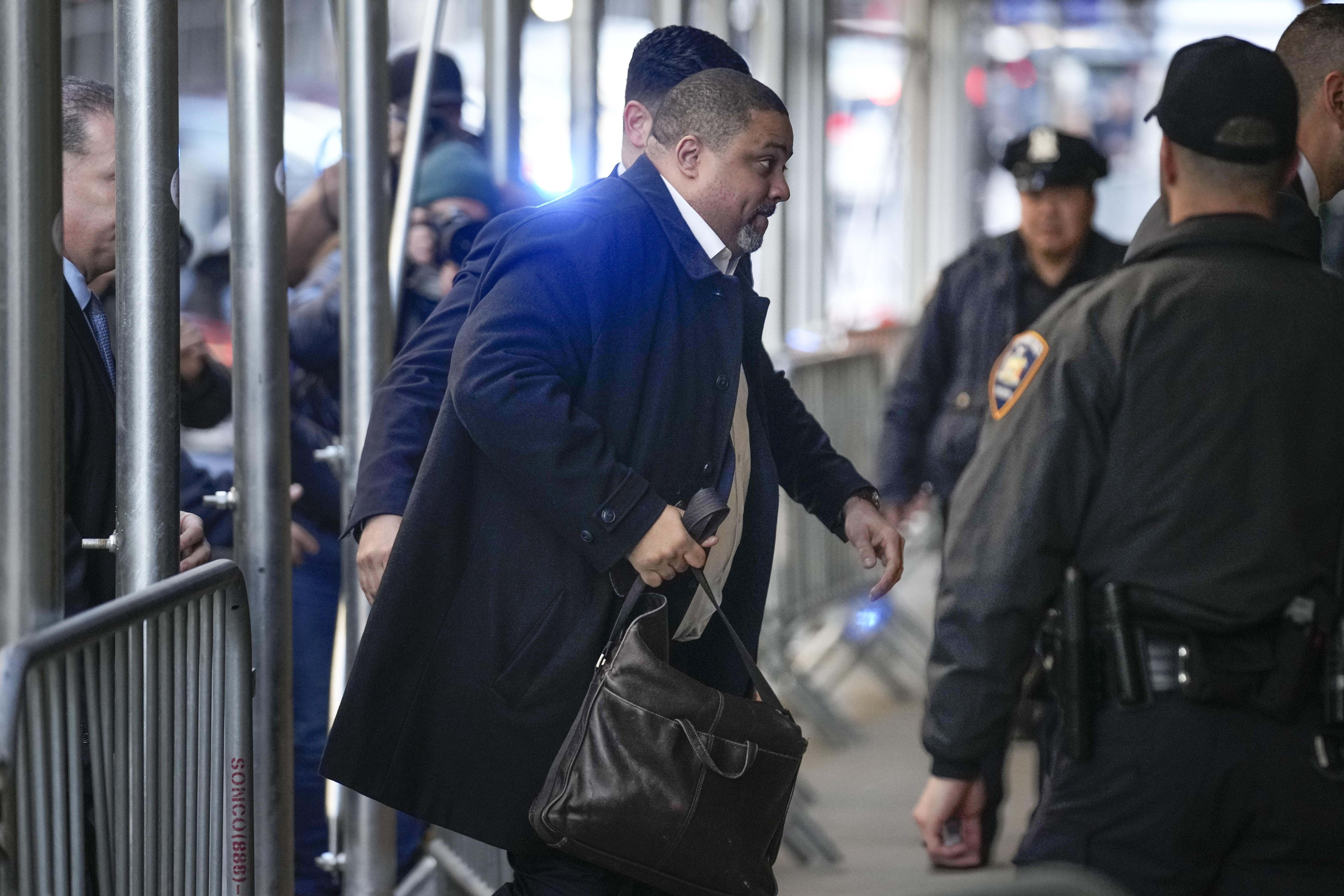 Surrounded by security, Manhattan District Attorney Alvin Bragg arrives at his office in New York. Photo / AP