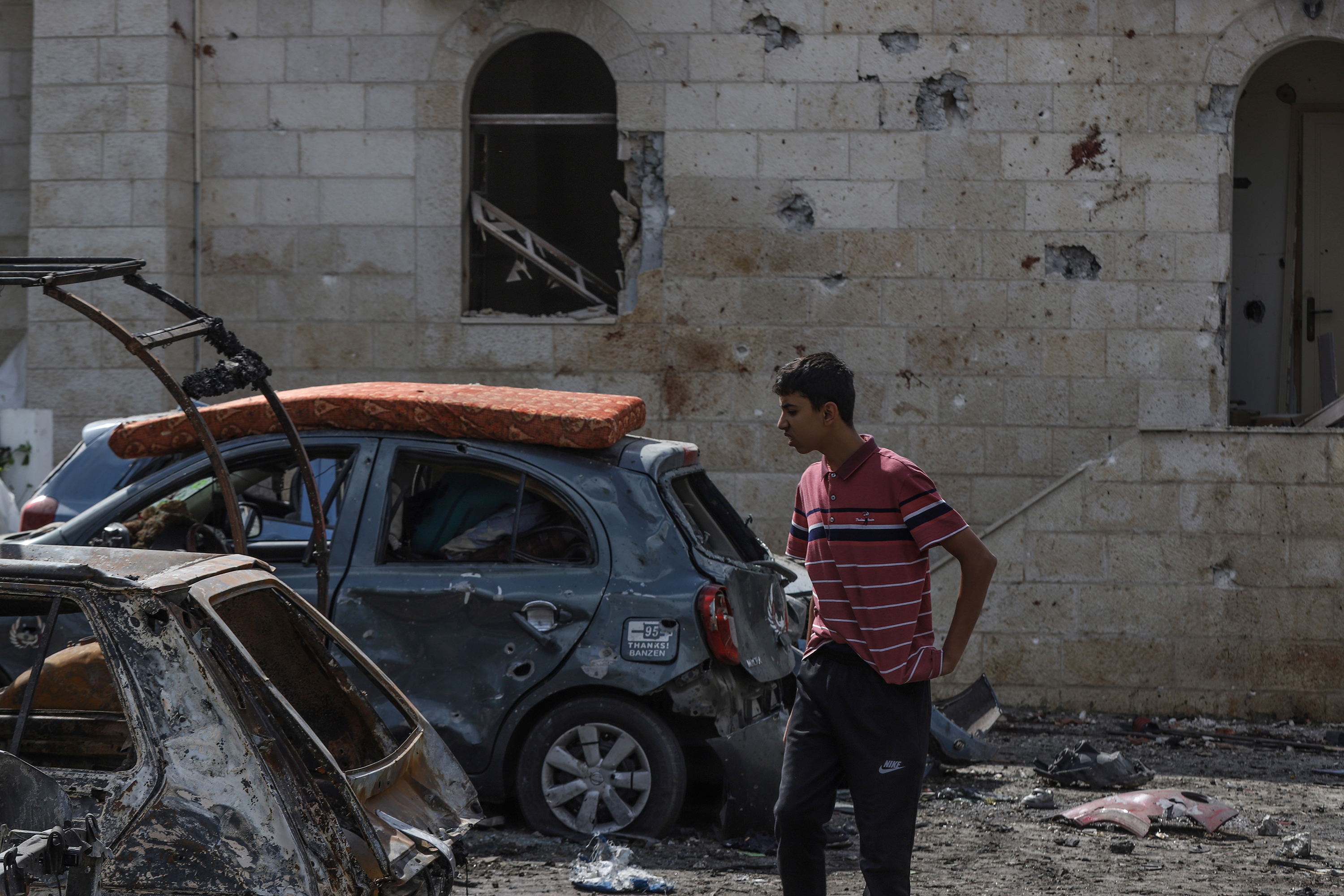 A teen inspects the destruction following the attack on the Ahli Arab Hospital. Photo / Getty Images