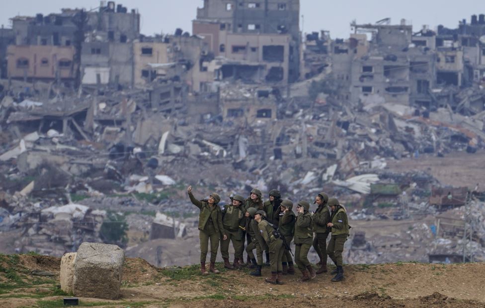 Israeli female soldiers pose for a photo at a position on the Gaza Strip border, in southern Israel. Photo / AP