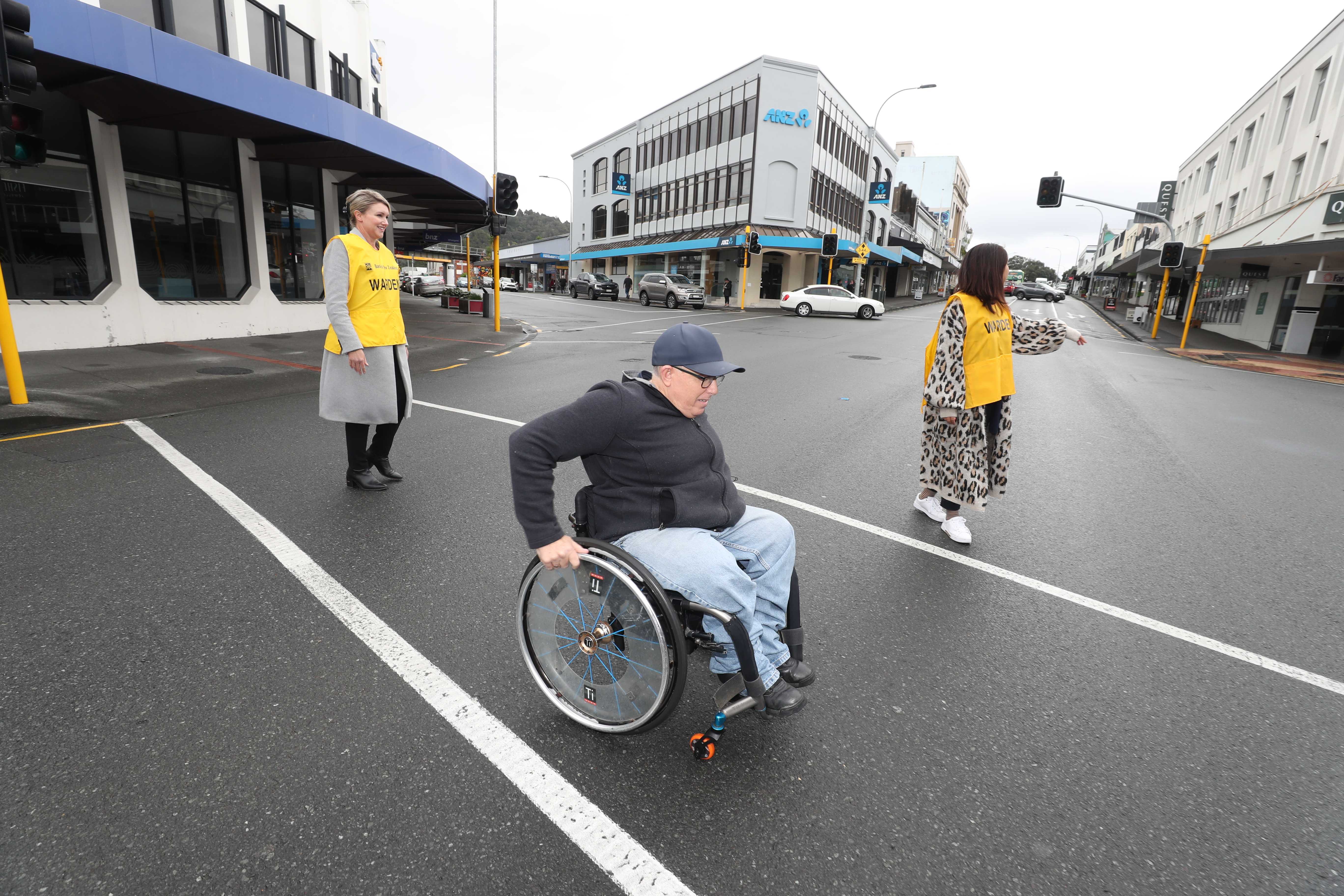 BNZ Whangārei staff help people get across the road at the busy Bank St, Rust Ave, Cameron St intersection, including Brad Williams from Kensington. BNZ’s Gina Chapman said the bank’s vaults have automatically locked and staff came out to talk to customers when they noticed pedestrians struggling to cross the road. Photo / Michael Cunningham 
