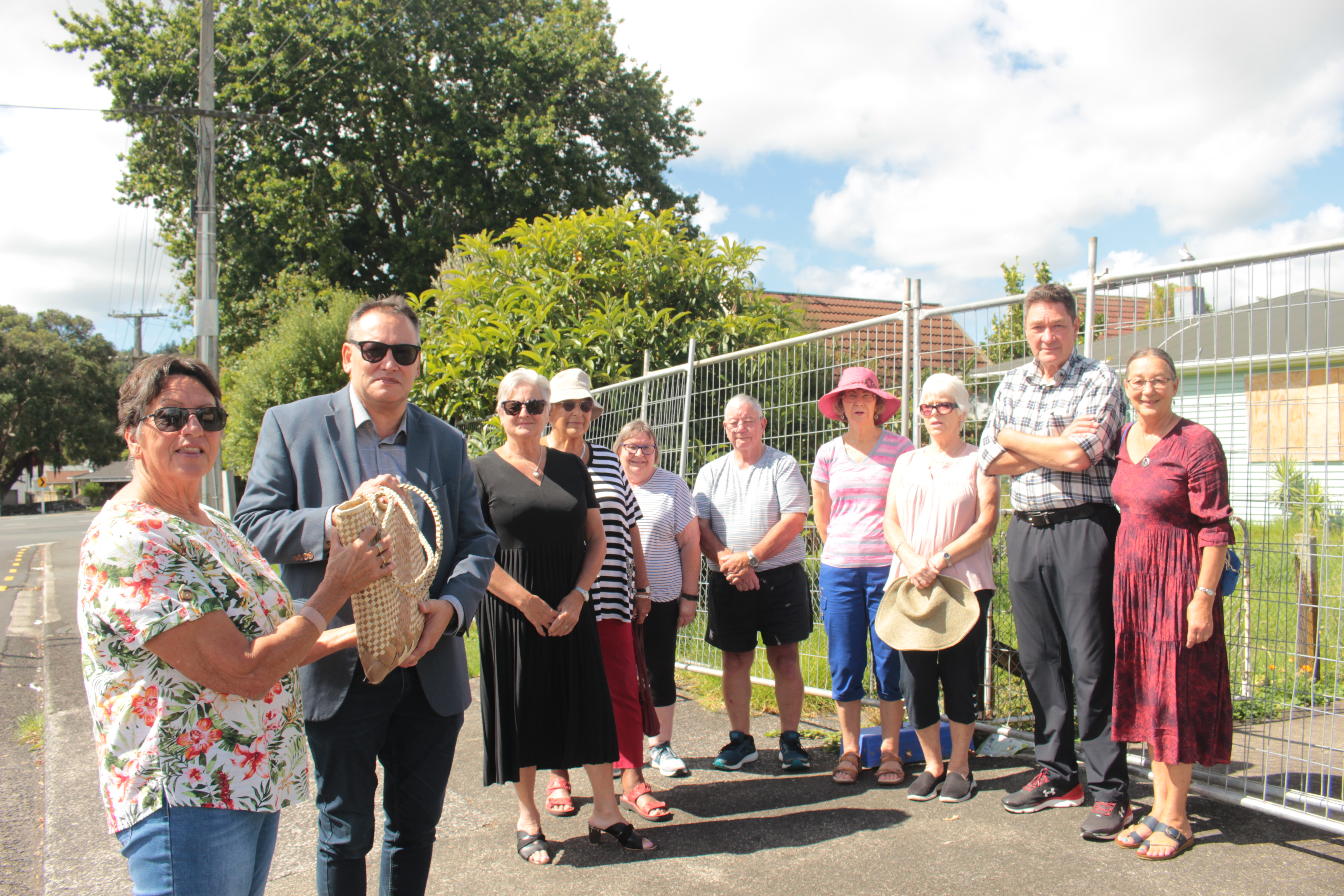 Kensington resident Veronica Turketo, left, presents the 1642-signature petition to Whangārei MP Shane Reti with the support of other residents. Photo / Denise Piper