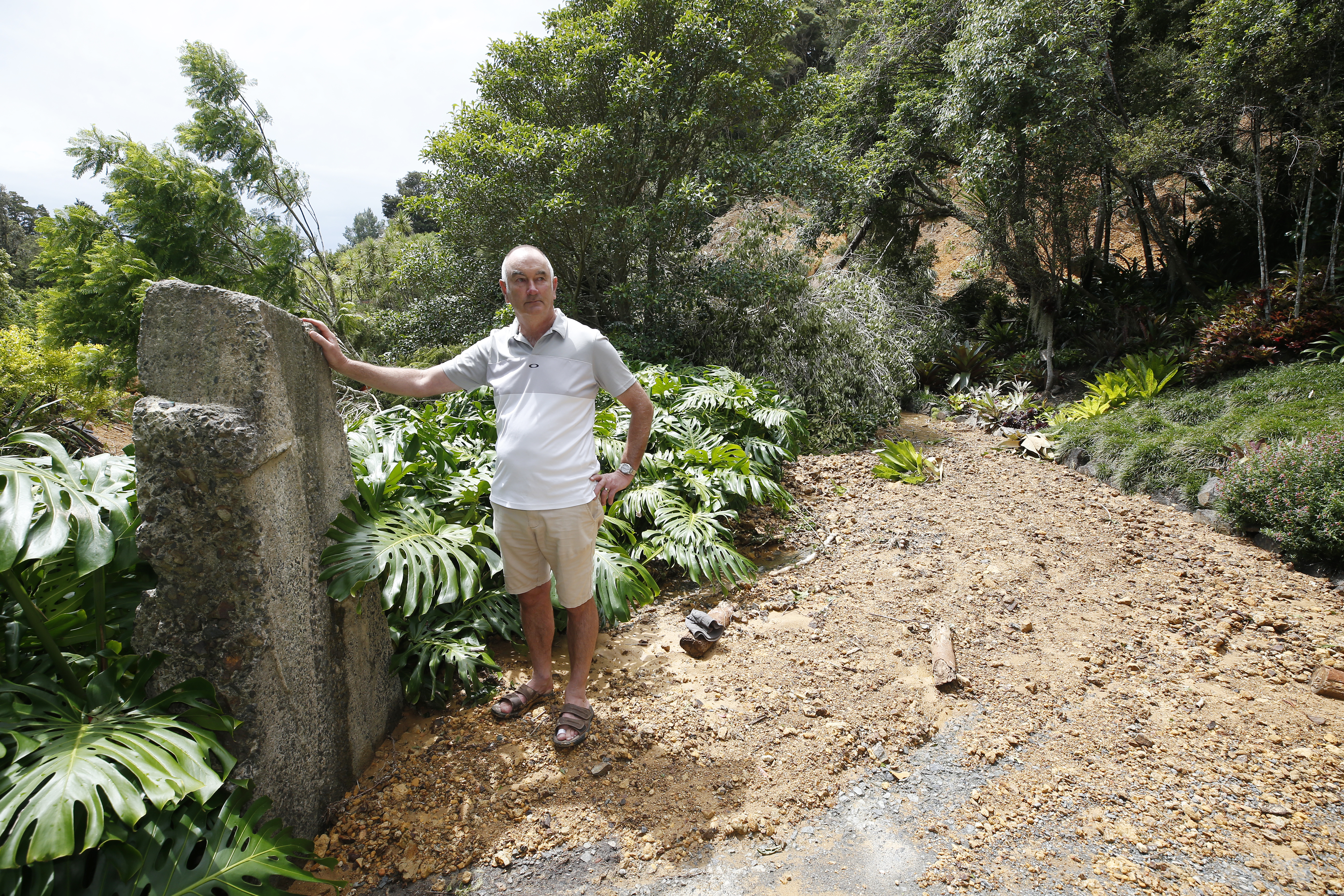 Behind where Garden Manager Guy Hessell stands is where visitors would usually walk up to the gardens. Quail Cafe is hidden behind the pile of mud and vegetation.  Photo / Michael Cunningham