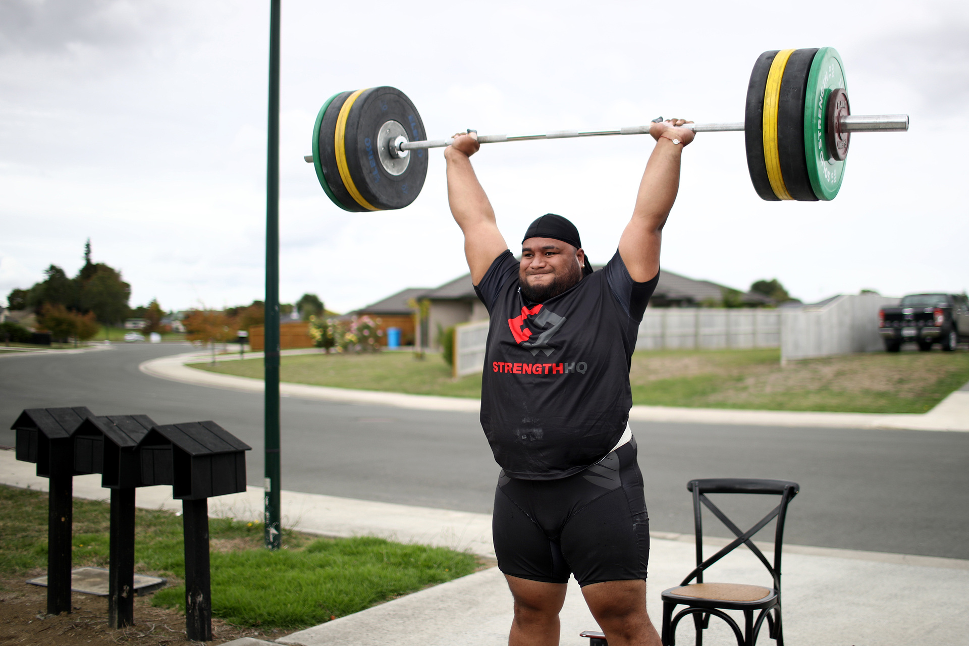 New Zealand Weightlifter David Liti training in isolation on the road and driveway outside his home due to the Coronavirus lockdown. Photo / Getty Images.