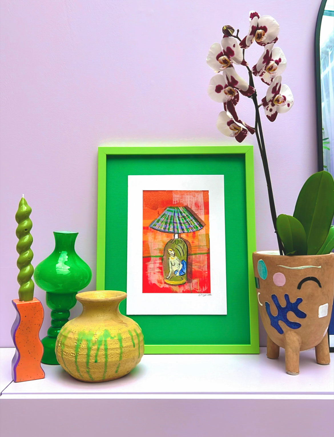 Show me your shelfie: The green lamp artwork by Evie Kemp.