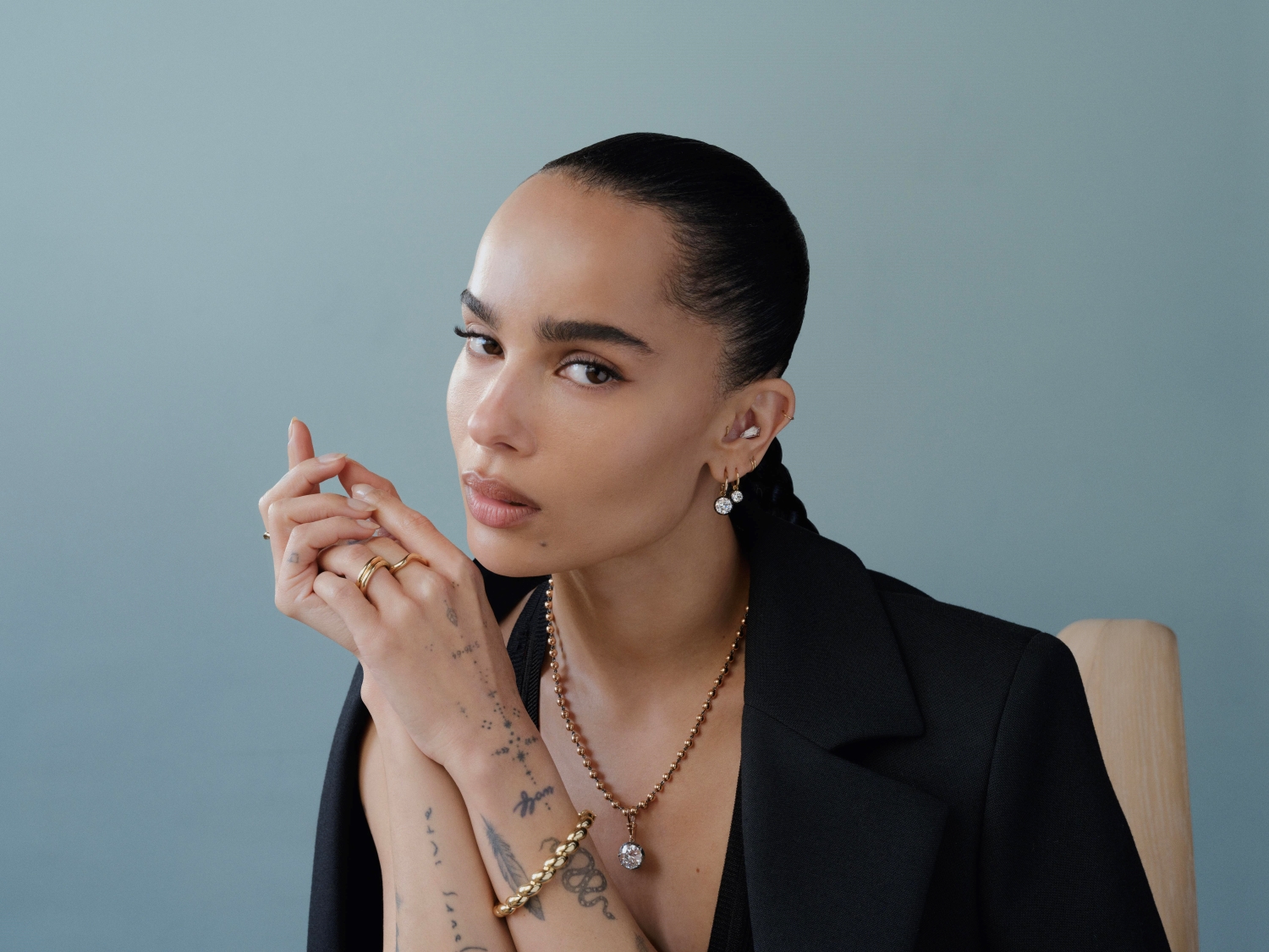 Zoe Kravitz wears Jessica McCormack pieces including Gypset diamond earrings with a Ball n Chain necklace and pendant.