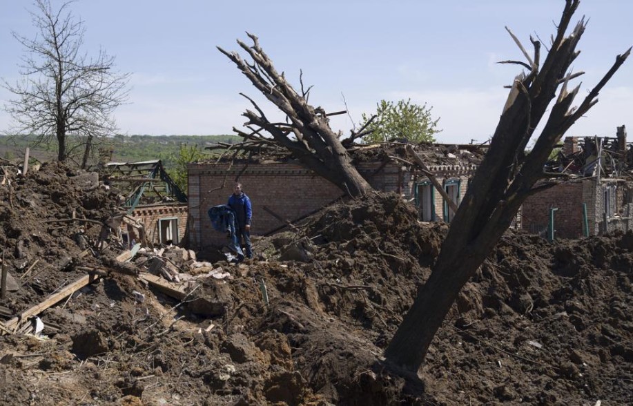 People stand in a destroyed residential area after a Russian airstrike in Bakhmut, Donetsk region, Ukraine. Photo / AP