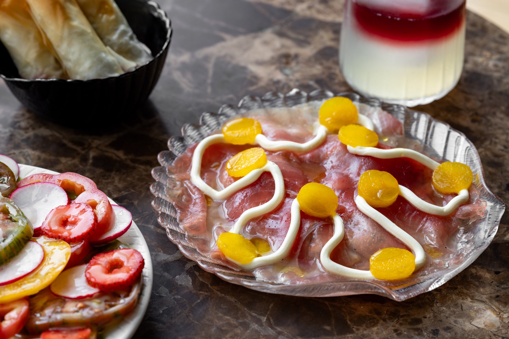 Suglaw of grilled pork, raw big eye tuna, nashi pear, macapuno, creme fraiche. Photo / Babiche Martens