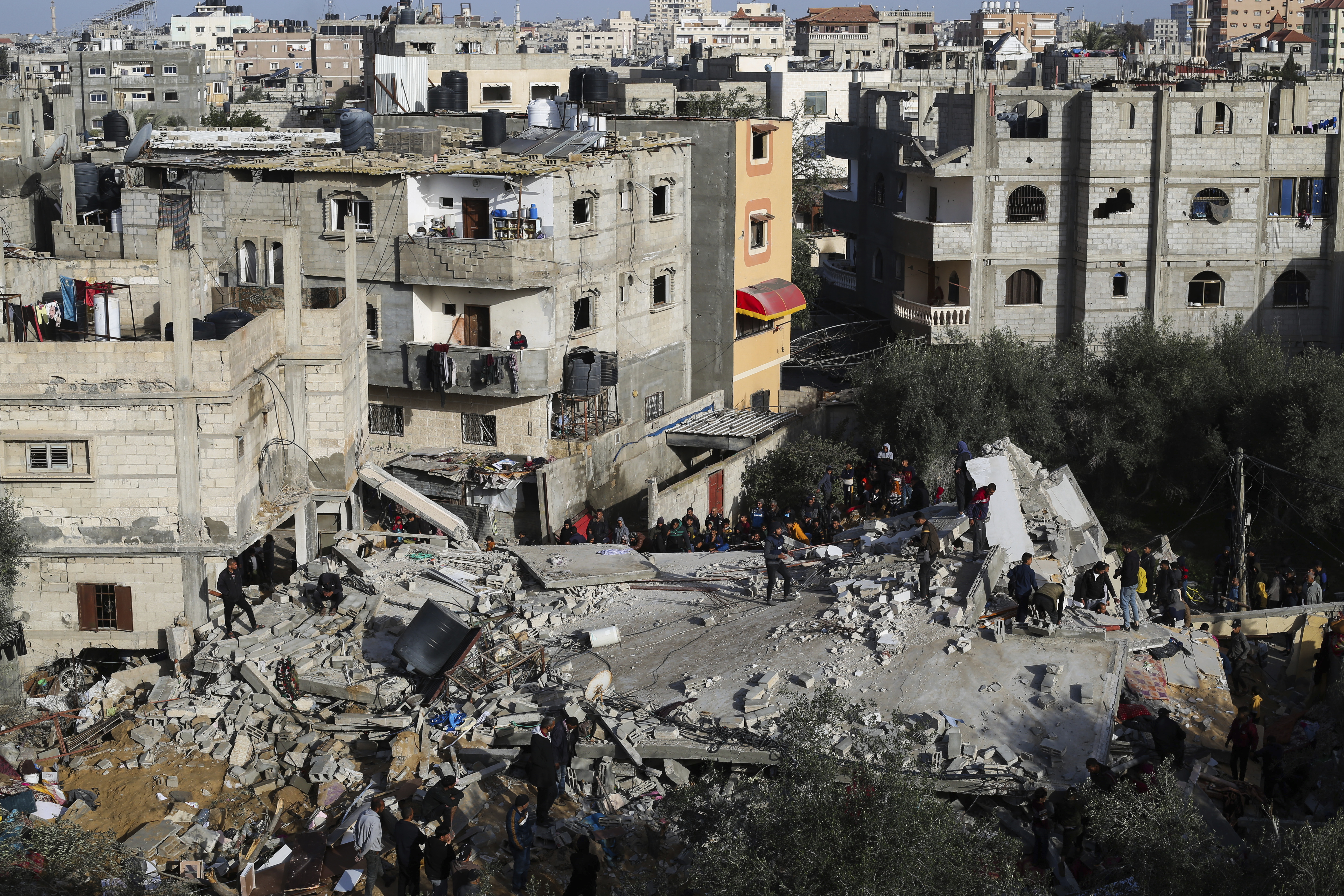 Palestinians look at the destruction after an Israeli strike on a residential building in Rafah, Gaza Strip, Sunday, March 3, 2024. Photo / AP