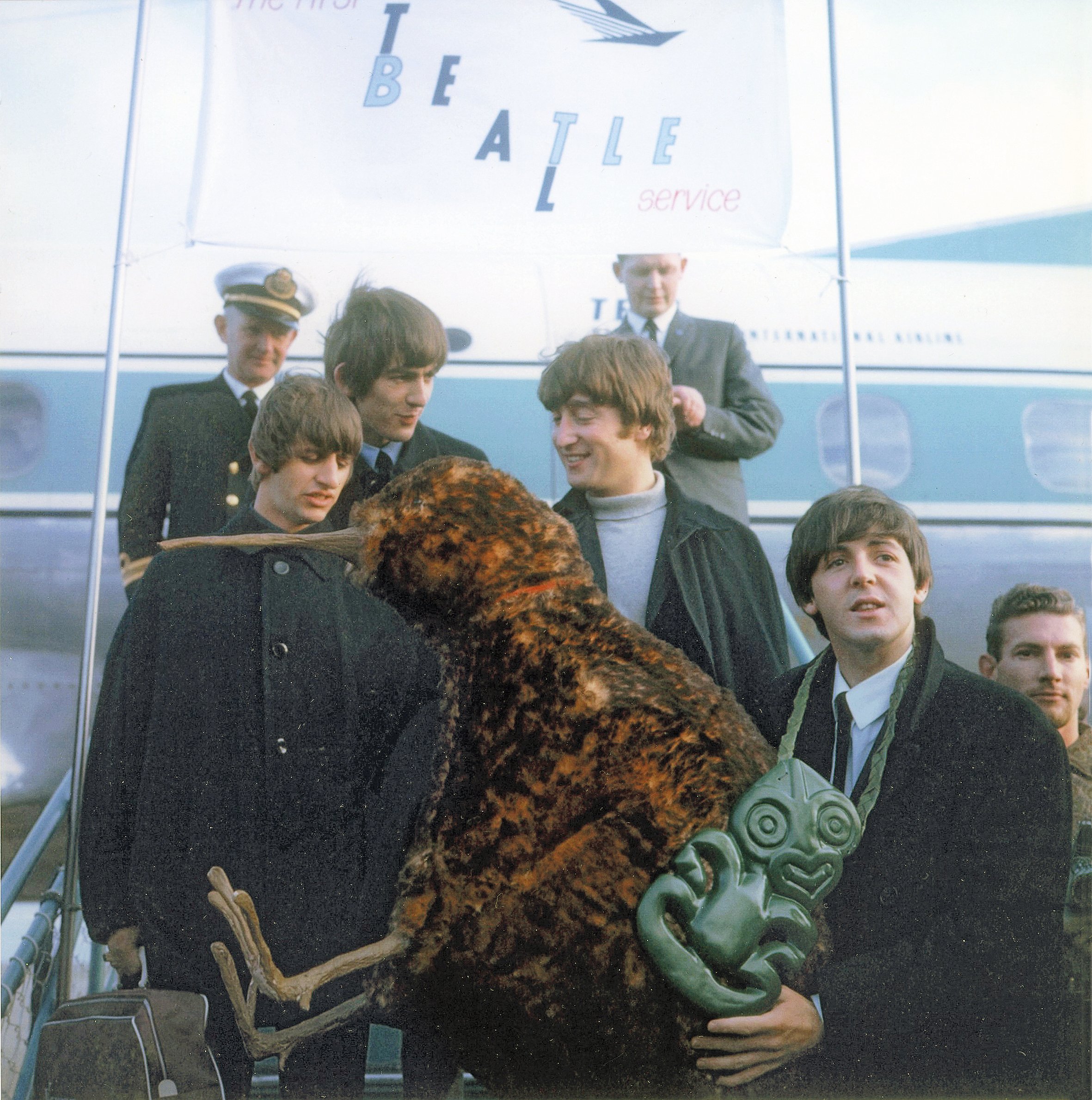 The Beatles walking on to the tarmac at Wellington Airport. Photo / Alexander Turnbull Library