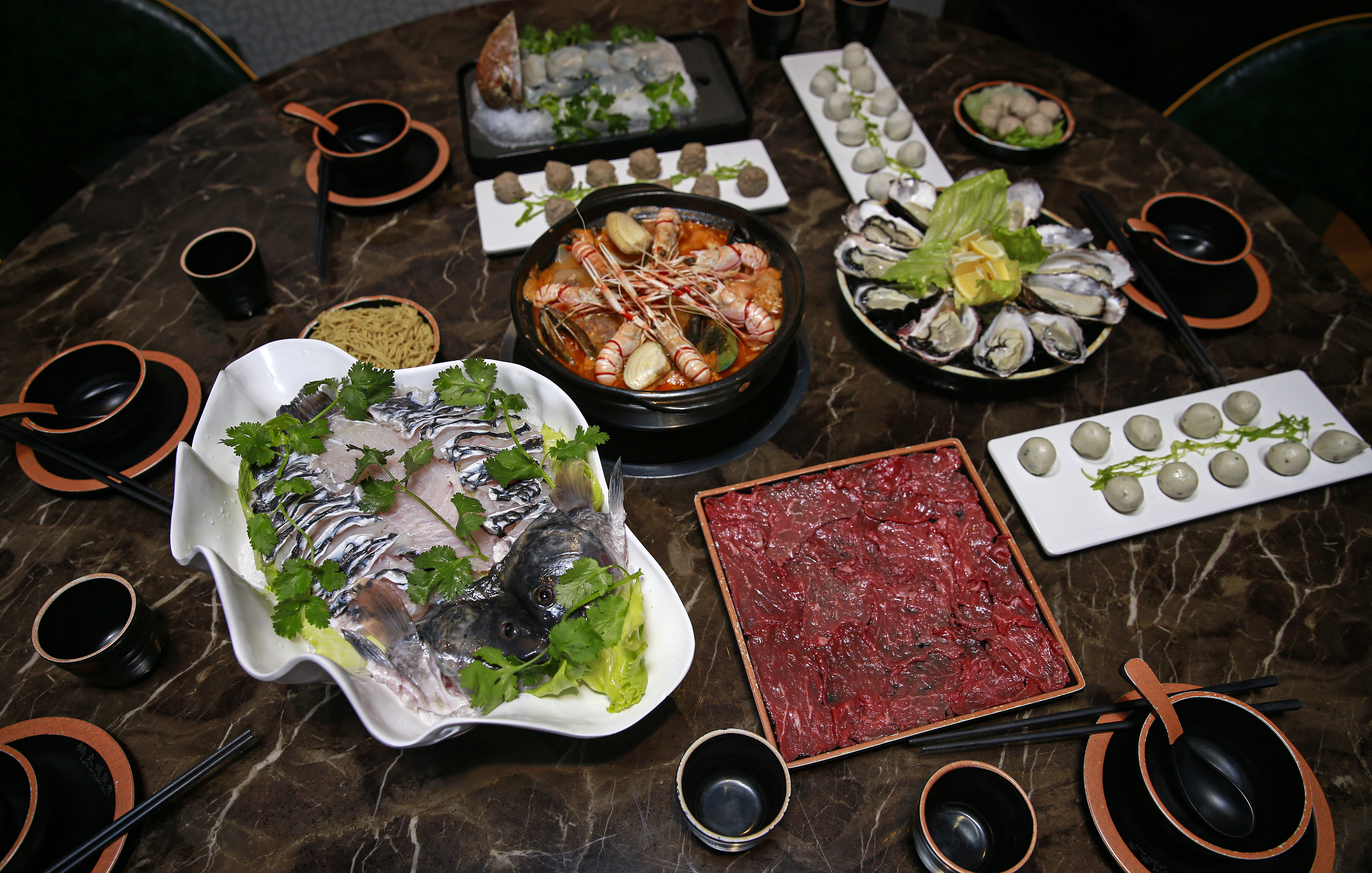 Guangzhou Hot Pot has auspicious Lunar New Year ingredients that include abalone, oysters, scampi, whole fish and long life noodles. Photo / Alex Burton
