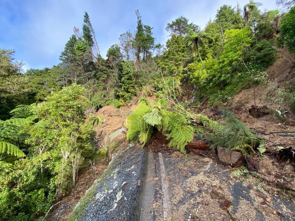 The massive slip, including a boulder covering two-thirds of the road, is blocking Russell Rd at Helena Bay, Northland. Photo / Denise Piper