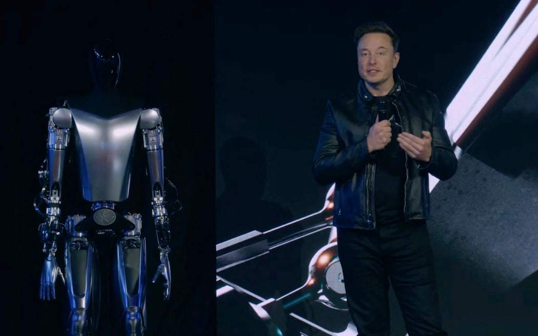 Tesla chief executive Elon Musk (right) with 'Optimus'. Photo / Tesla