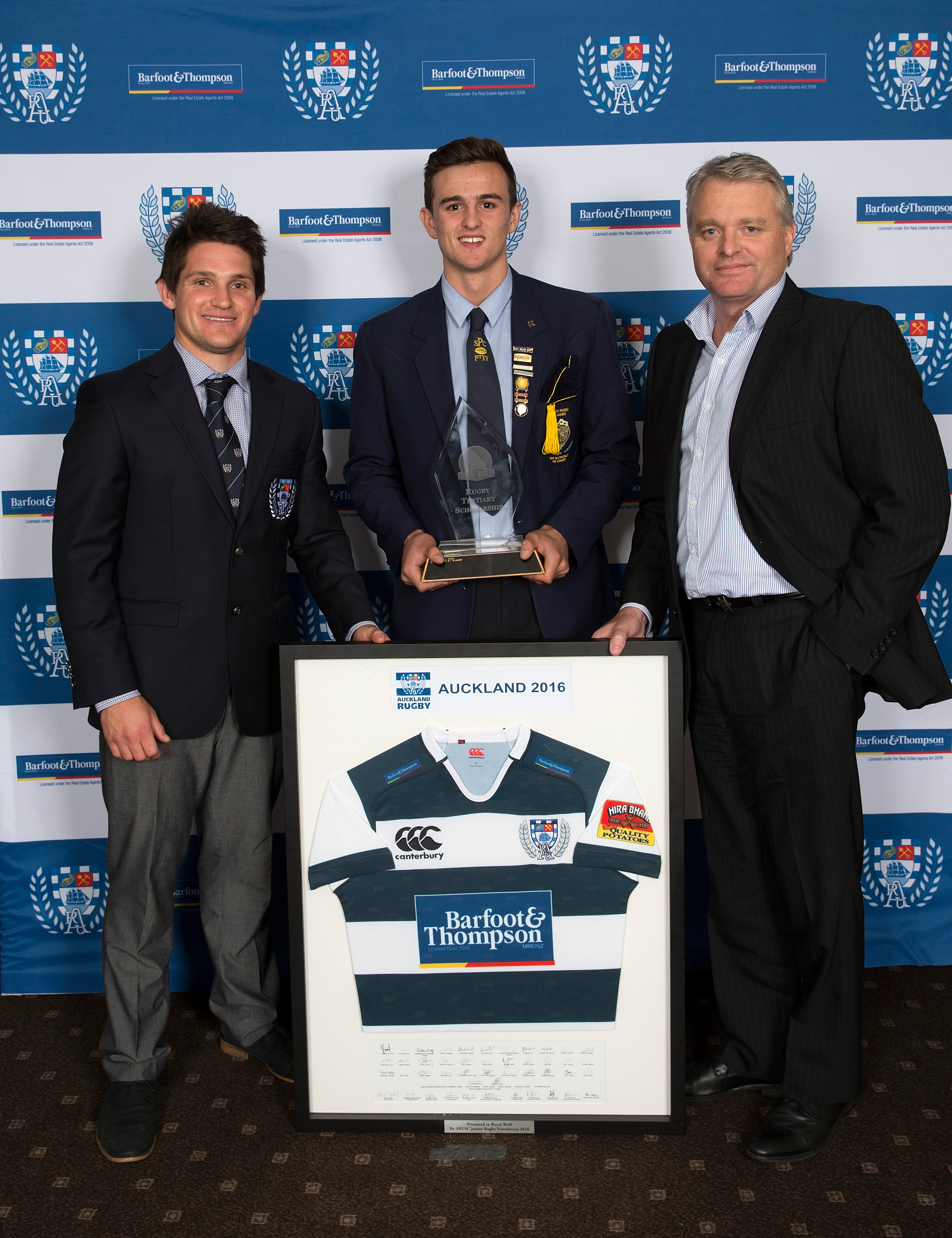 Harry Plummer flanked by Auckland No 10 Simon Hickey, left, and executive general manager of Royal Wolf NZ Paul Creighton.