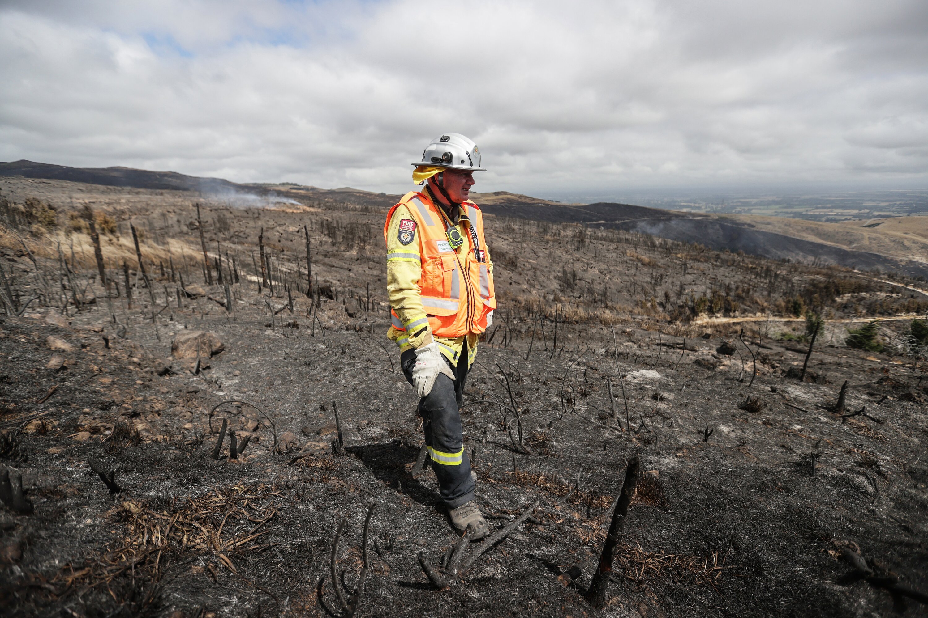 Operations manager Rob Hands surveys fire damage in the Port Hills fire as firefighters continue dampening down remaining hot spots. Photo / Chris Skelton