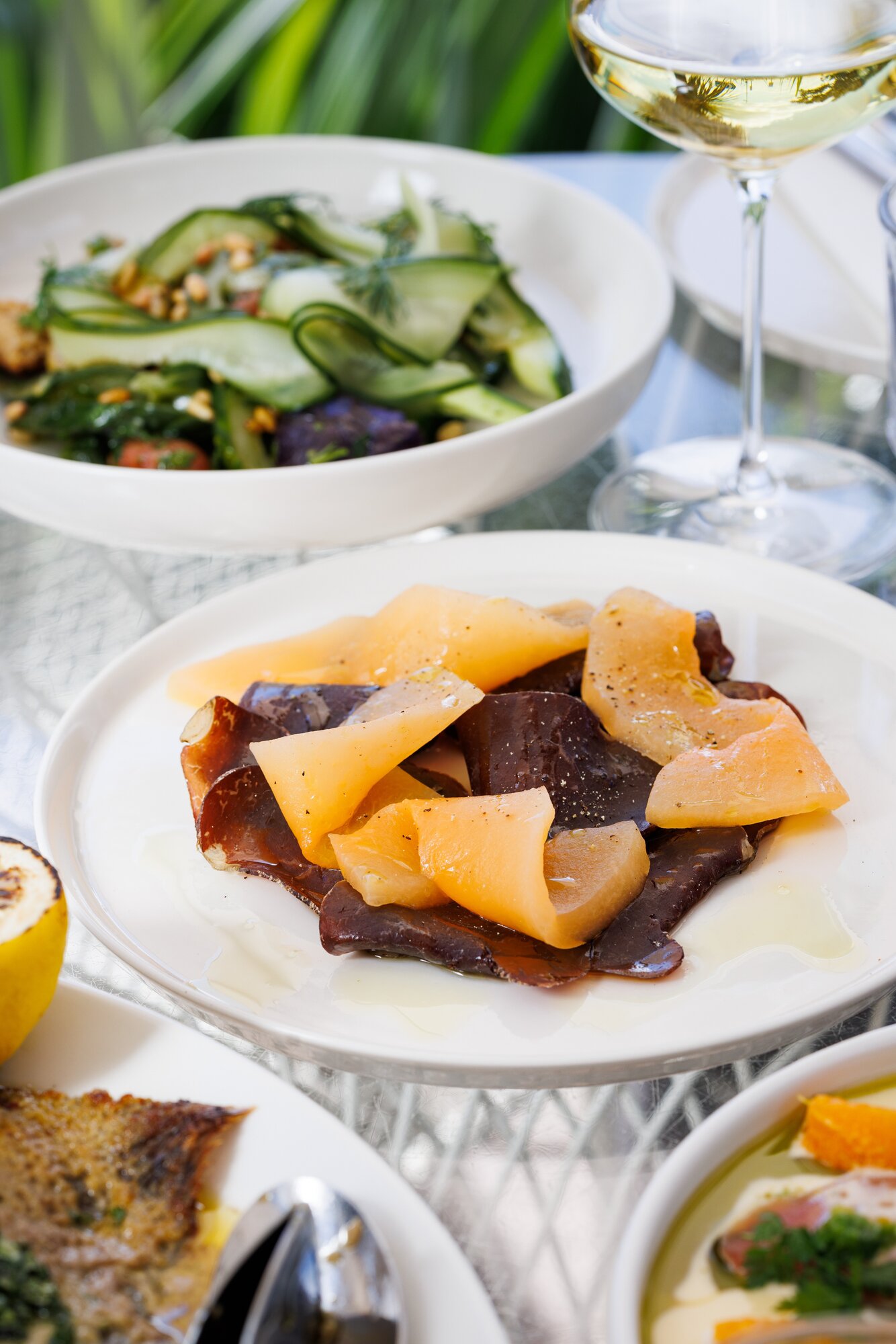 Takapuna Beach Cafe's wagyu bresaola with rock melon, onion and extra virgin olive oil. Photo / Babiche Martens