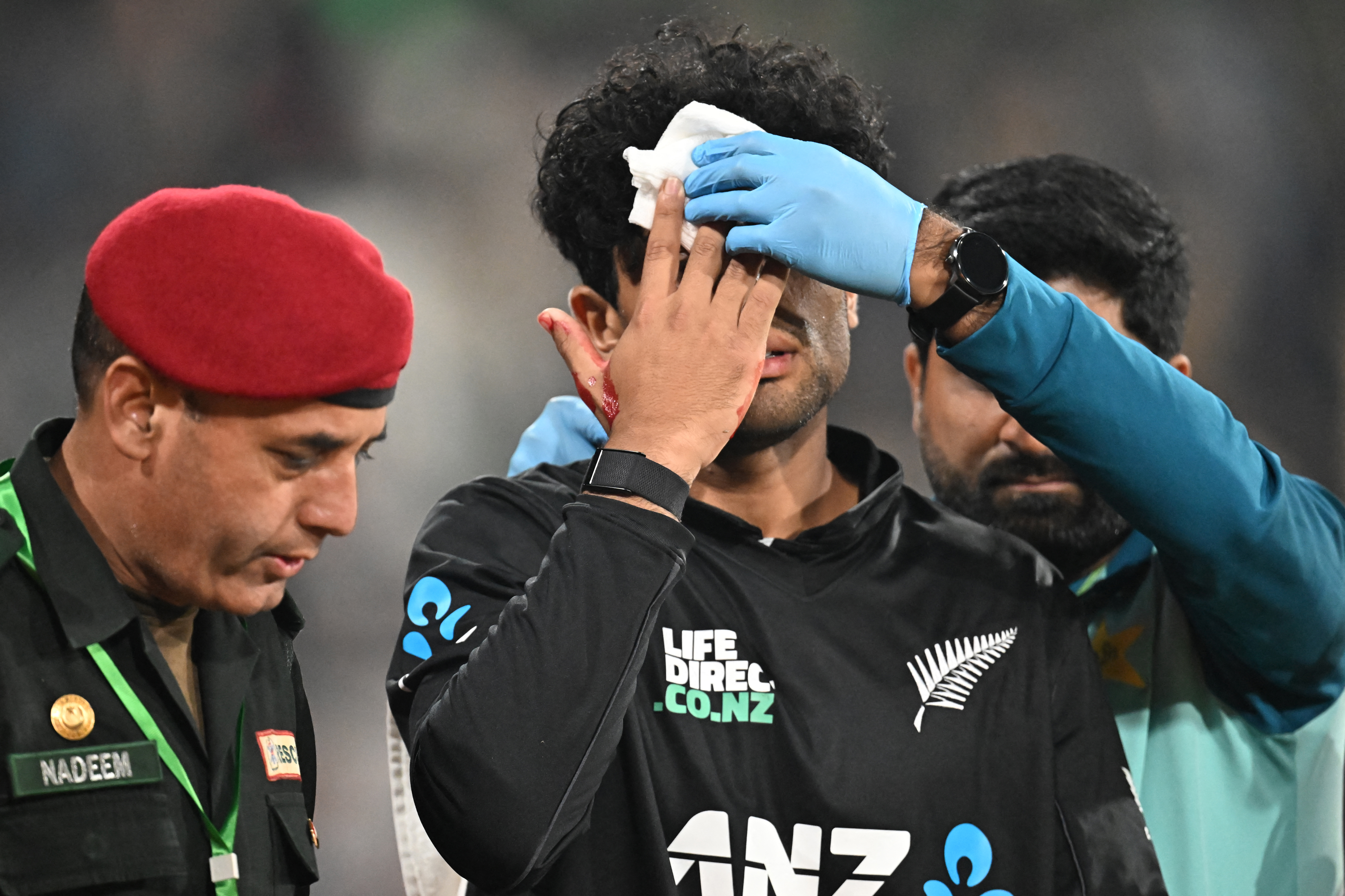 Rachin Ravindra receives medical attention after being hit on the head. Photo / AFP