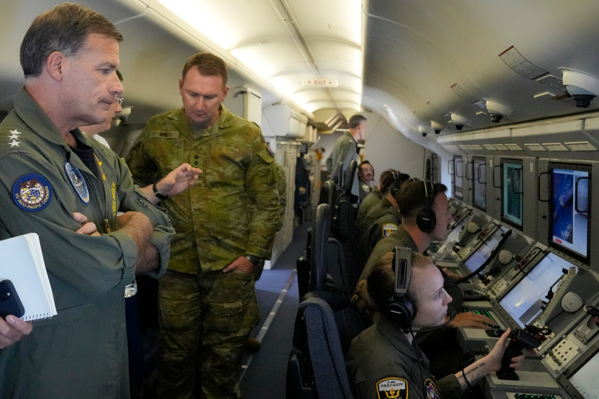 Admiral John C. Aquilino, (left), Commander of the US Indo-Pacific Command on board a US P-8A Poseidon reconnaissance plane. Photo / Aaron Favila, AP