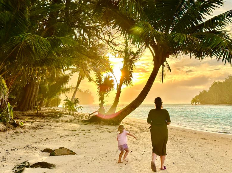 Aimee and Riley walk on the beach near Muri Lagoon, Rarotonga. Photo / Tim Roxborogh