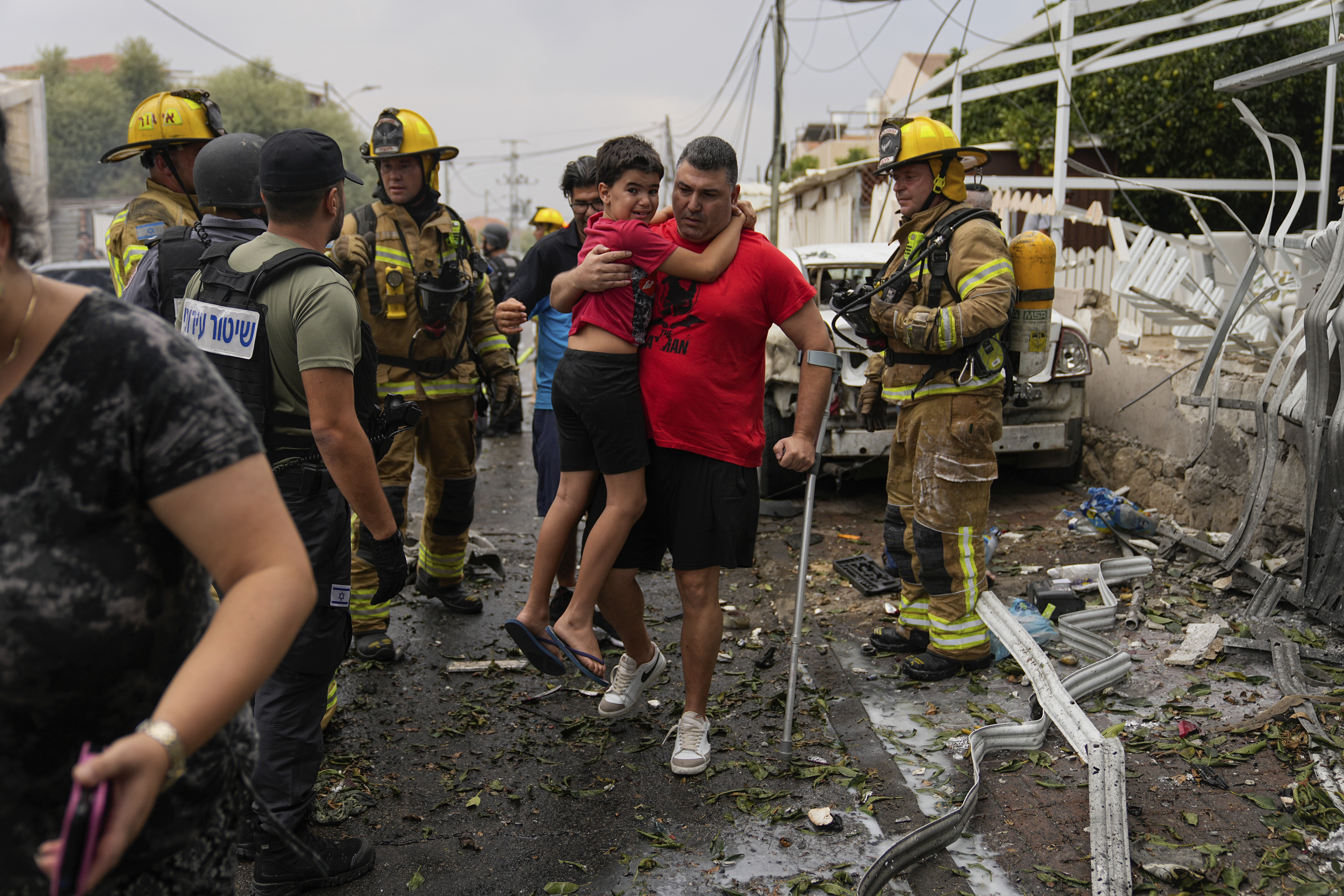 Israelis evacuate a site struck by a rocket fired from the Gaza Strip, in Ashkelon, southern Israel. Photo / AP