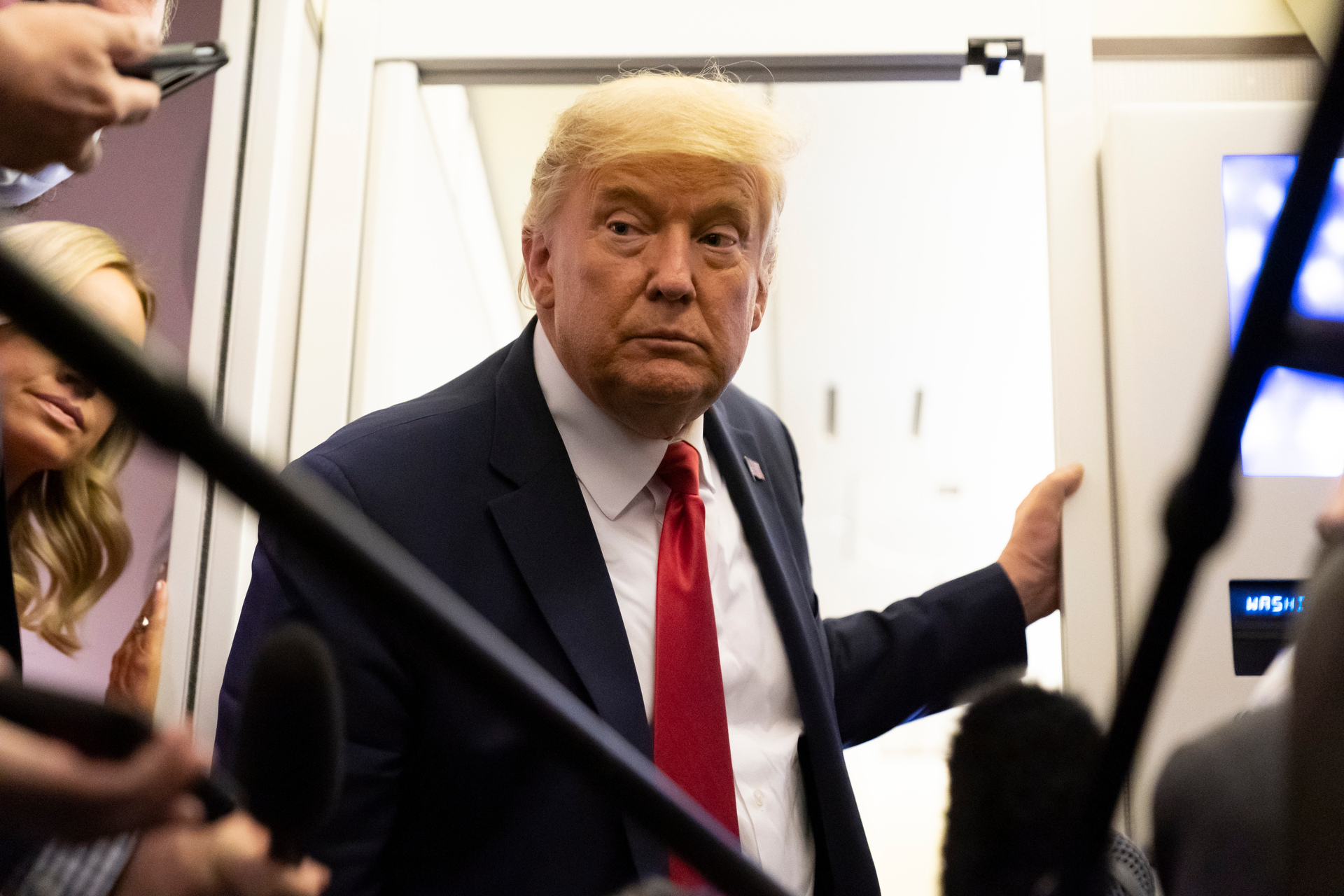 US President Donald Trump talks to reporters on Air Force One after a campaign rally on October 19. Trump has long had his sights on tech companies. Photo / AP