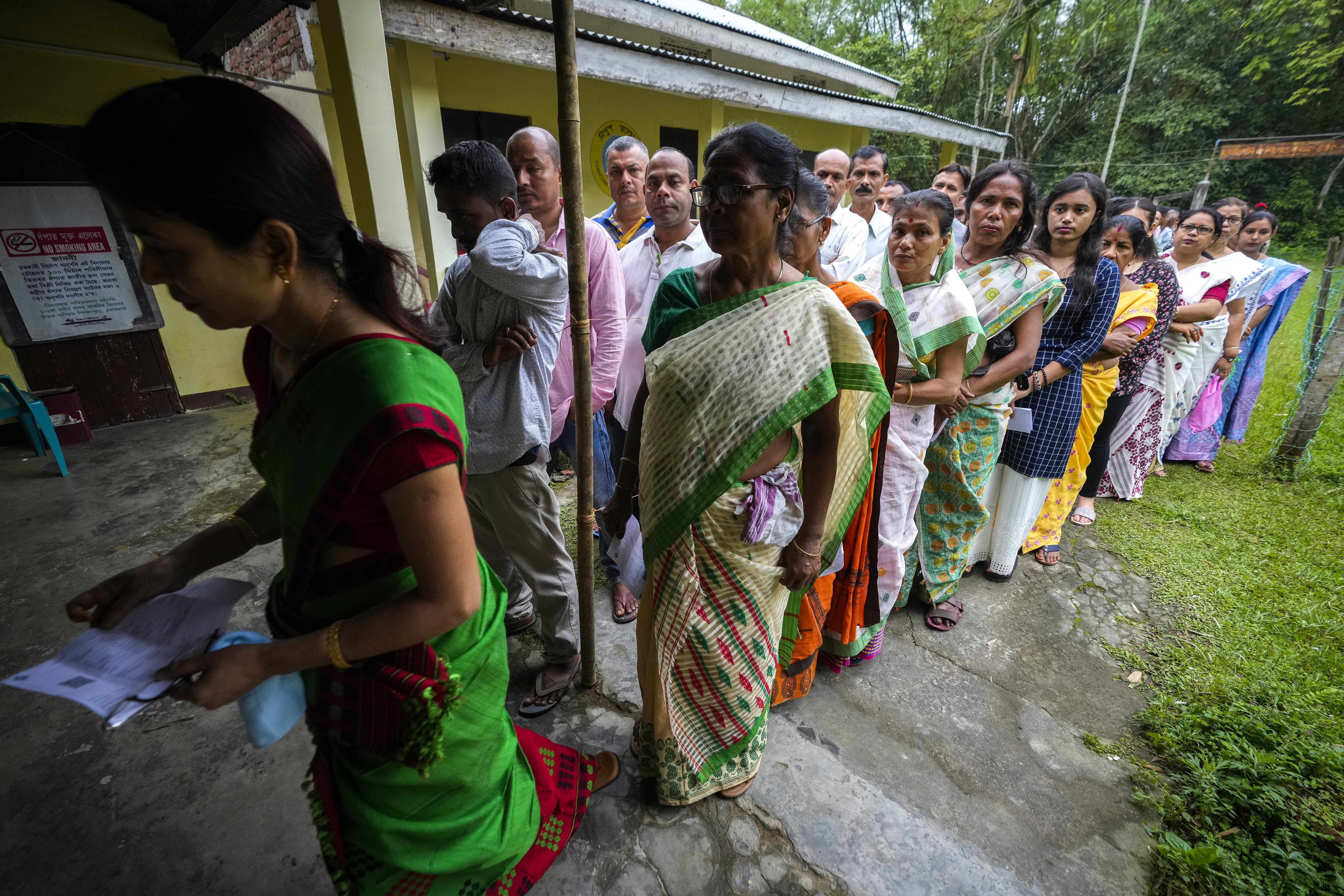 People stand in queue to cast their votes during the first round of polling of India's national election in Bahona village, northeastern Assam, India. Photo / AP�