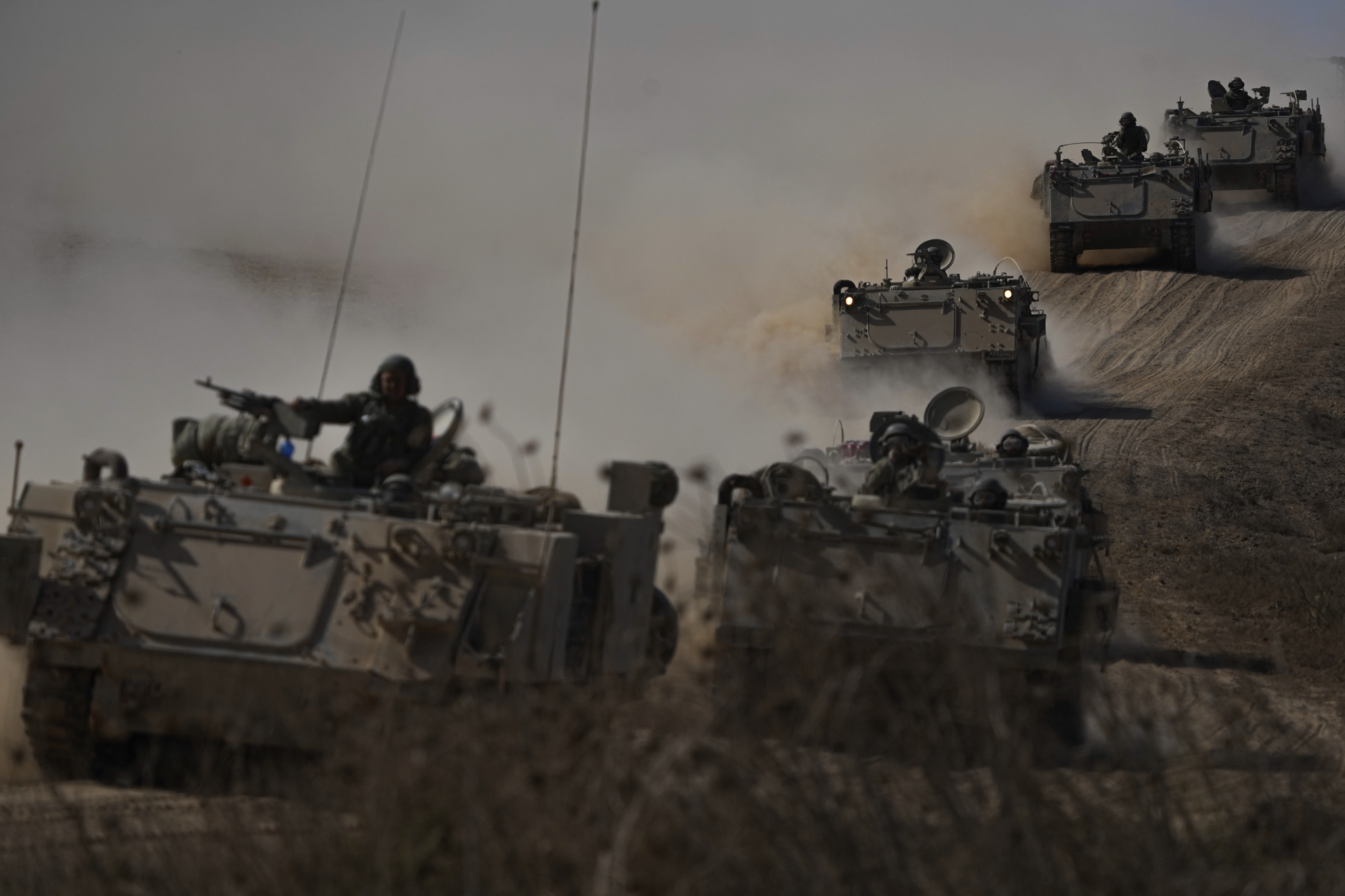 Israeli APCs head toward the Gaza Strip border in southern Israel. Photo / AP