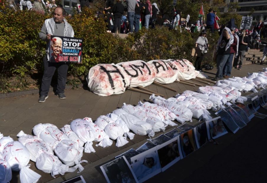 Protesters place white sacks representing the bodies of people killed in Gaza during a pro-Palestinian demonstration at Freedom Plaza in Washington. Photo / AP