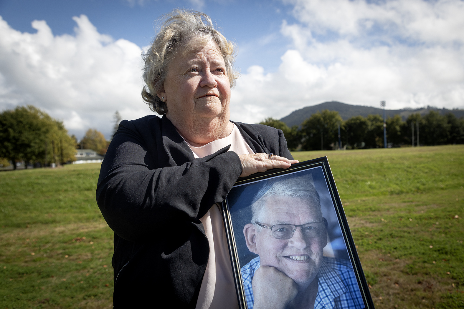 Denise Sturt holds a photo of her late husband Charles, a councillor who advocated for the new skatepark. Photo / Andrew Warner