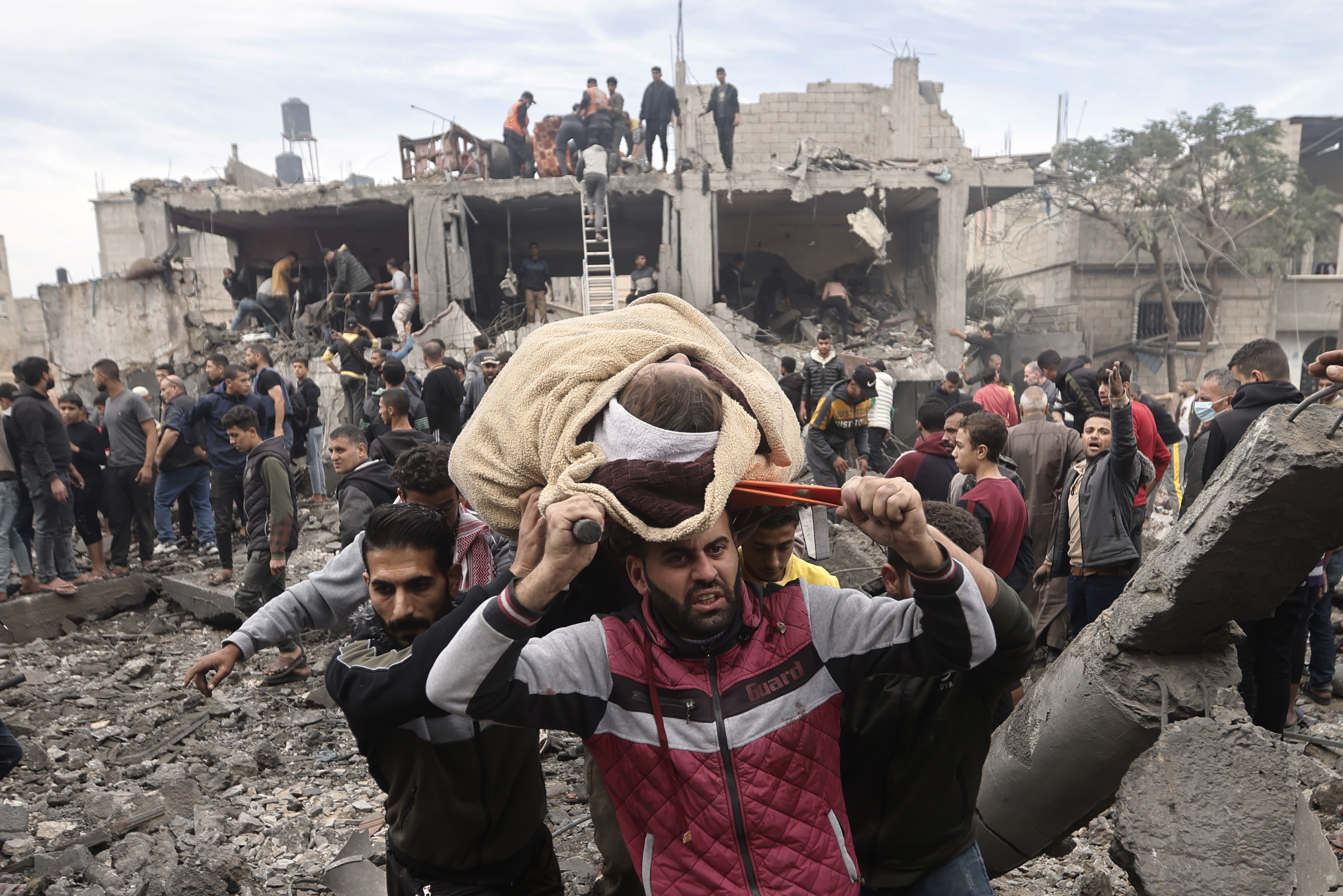 Palestinians evacuate a wounded woman following Israeli airstrikes in Khan Younis refugee camp, southern Gaza Strip. Photo / AP