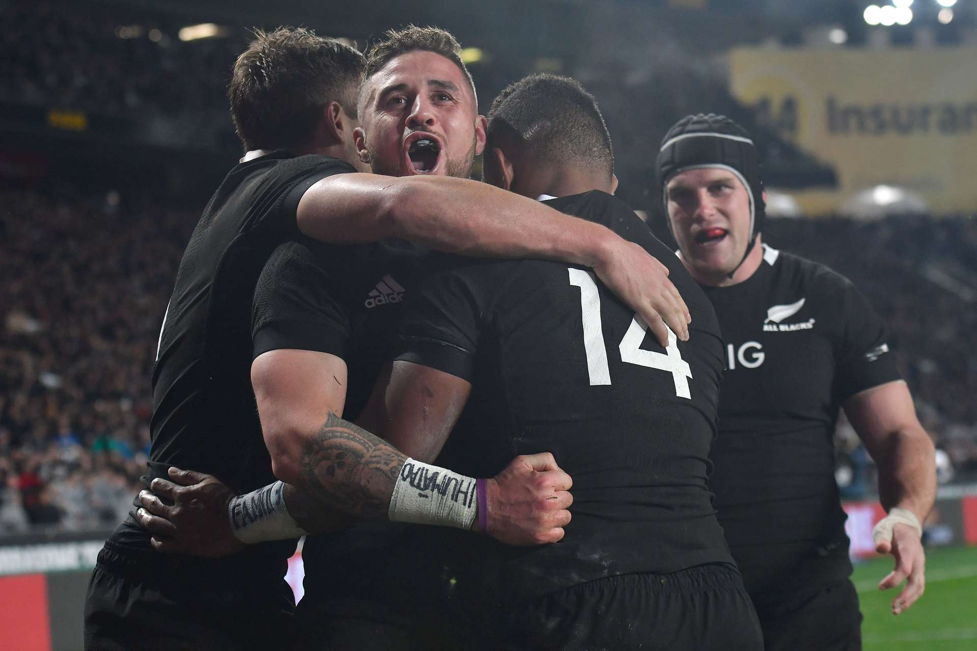 TJ Perenara's protest wristband is obvious as he celebrates Sevu Reece's try during the All Blacks vs Australia match at Eden Park. Photo / Photosport