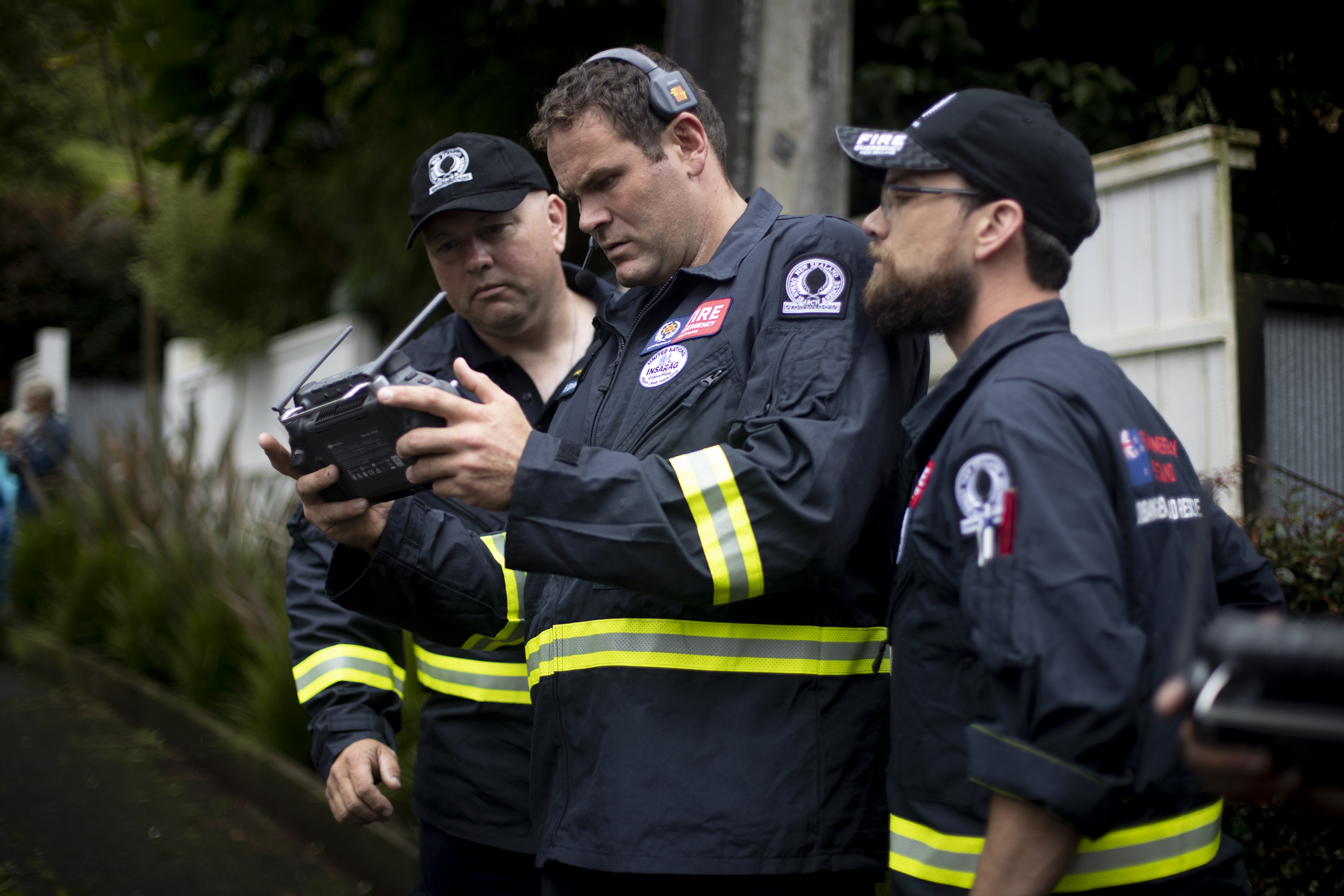 Members of Urban Search and Rescue team working with structural engineers are assessing red stickered homes in Titirangi following the devastating floods that hit Auckland on Friday. Photo / Dean Purcell