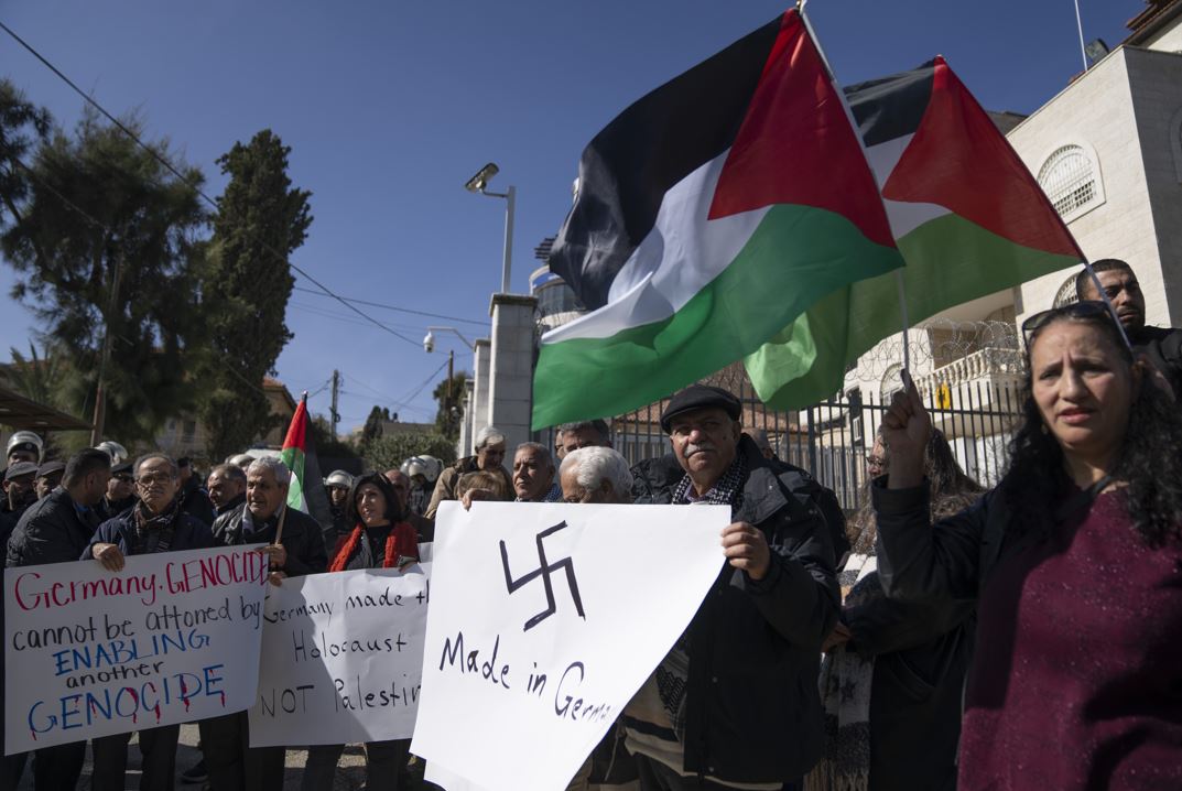 Palestinian activists carry posters and chant slogans while protesting against Germany's support for Israel in the Gaza war. Photo / AP