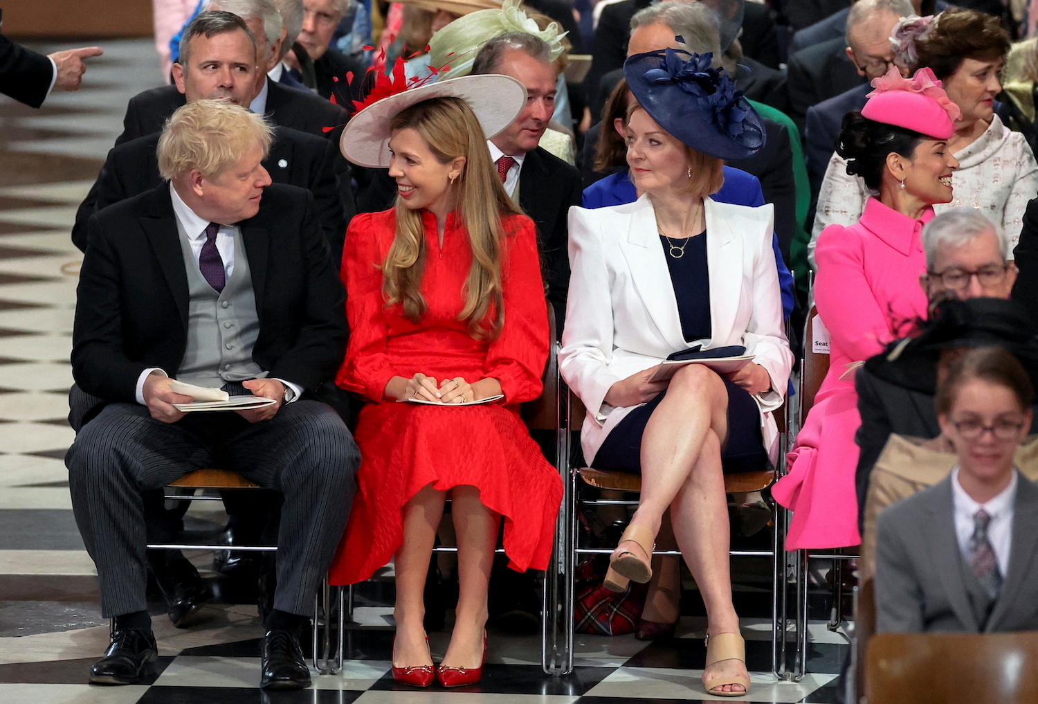 British Prime Minister Boris Johnson and his wife Carrie Johnson look at each other next to British Foreign Secretary Liz Truss as they attend the National Service of Thanksgiving. Photo / AP