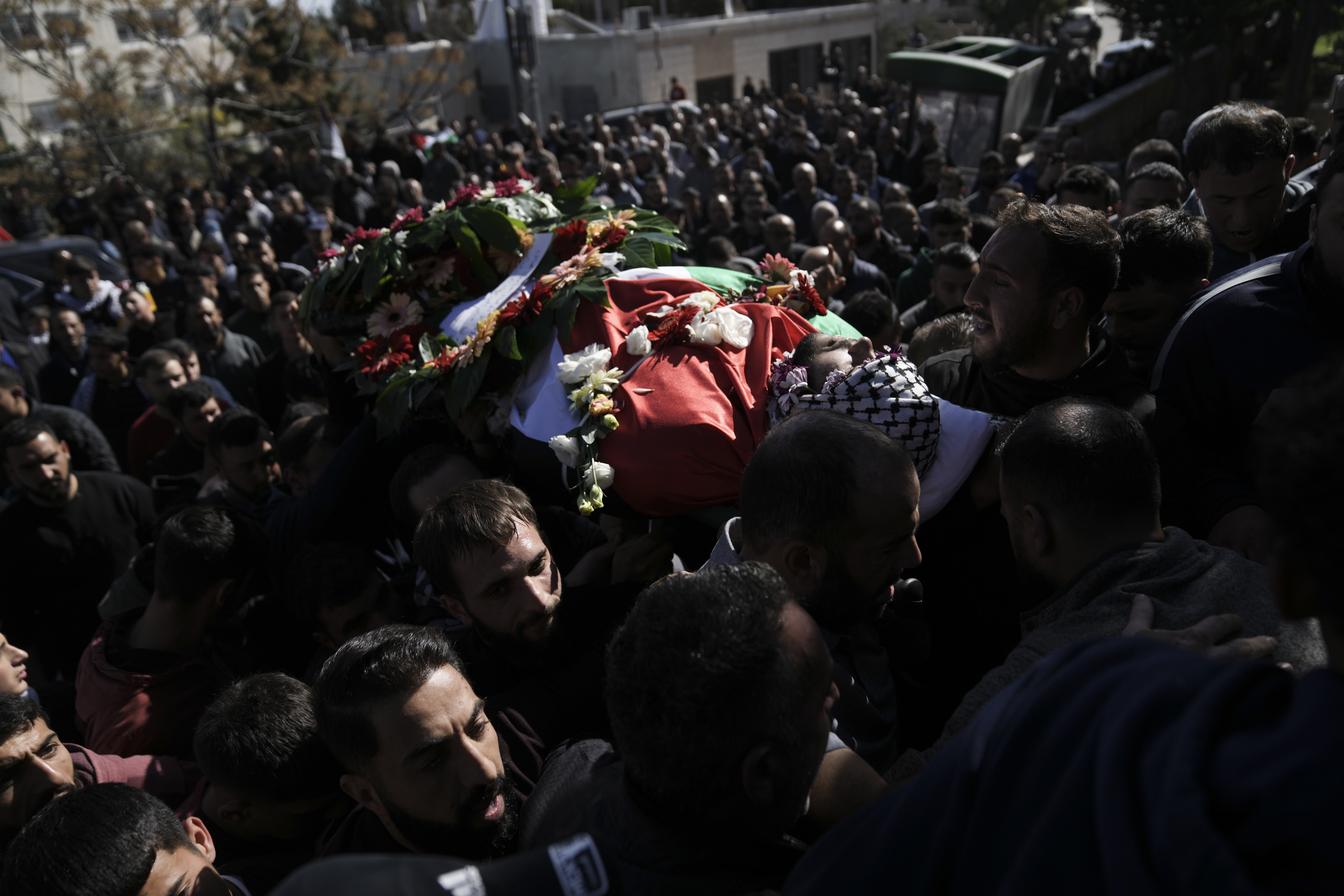 Relatives carry the body of 17-year-old American Tawfiq Ajaq at his funeral in his family’s Palestinian home village in Al-Mazra'a ash-Sharqiya, West Bank. Photo / AP