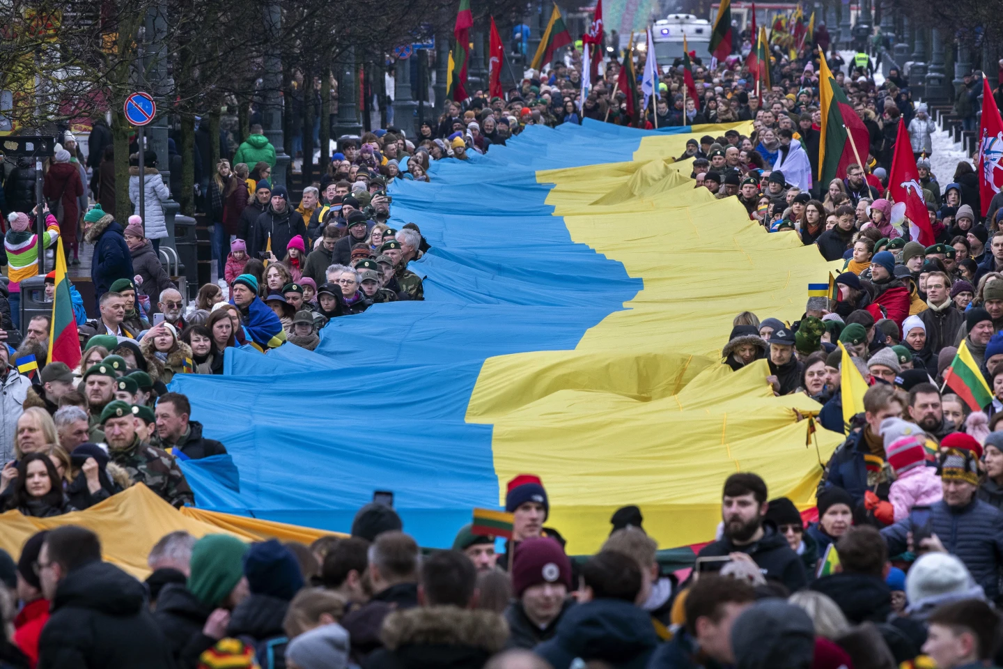 People carry a giant Ukrainian flag to protest against the Russian invasion of Ukraine during a celebration of Lithuania's independence in Vilnius, Lithuania. Photo / AP