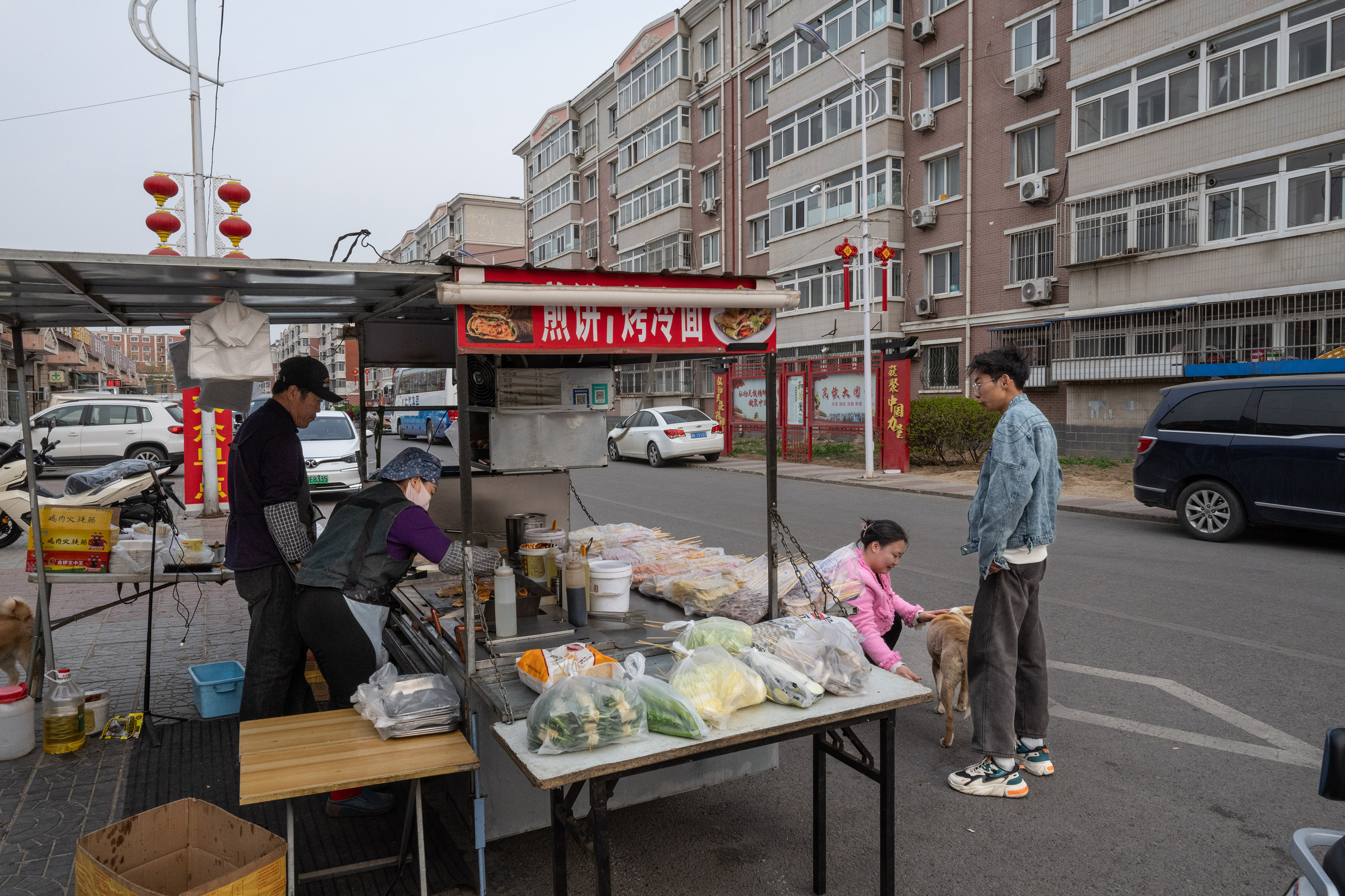 Selling Chinese breakfast crepes and grilled noodles outside a residential complex, in Zhangjiawan, in April. Some vendors have complained that officials have made their lives harder by policing where they can set up. Photo / Gilles Sabrié, The New York Times