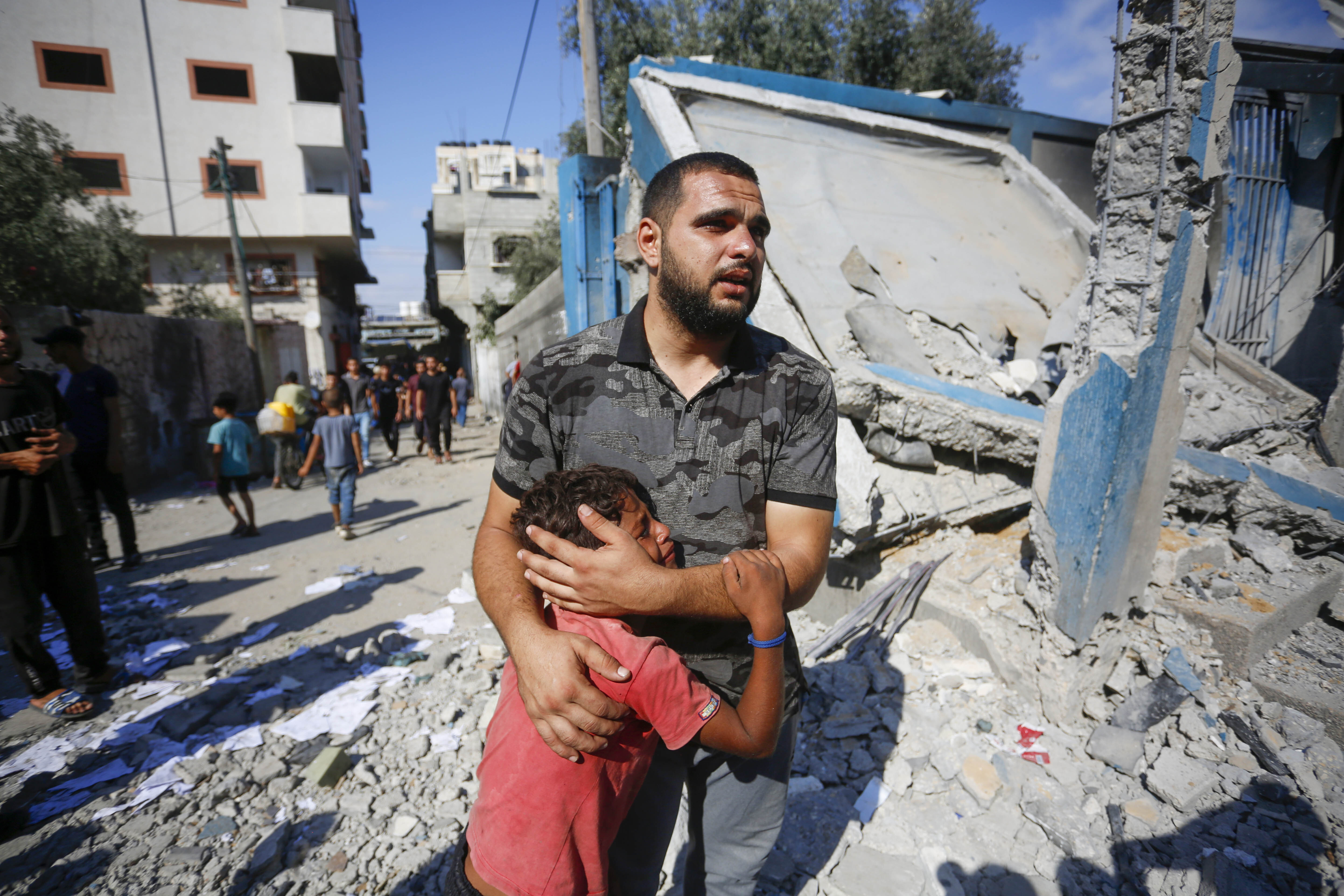 Relatives of Palestinians, who were killed by Israeli attacks on UNRWA school, mourn as Palestinians examine the destroyed makeshift tents and shelters in Nuseirat Refugee Camp of Deir al-Balah, Gaza on July 14, 2024. Photo / Anadolu via Getty Images