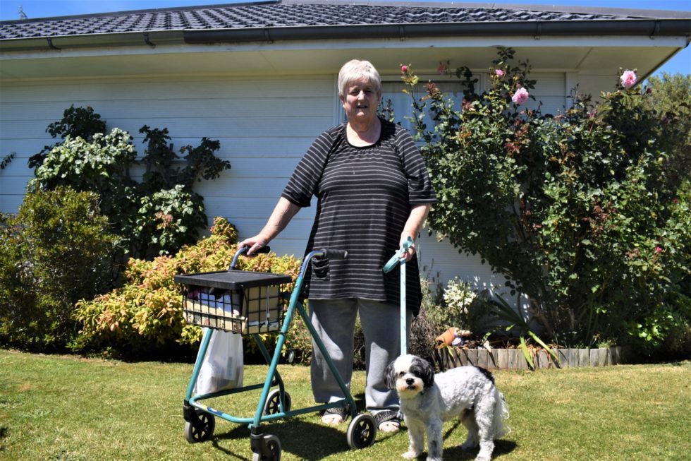 Dorothy Hutton with her dog Oska outside the house she's been asked to vacate. Photo / Wairarapa Times-Age 