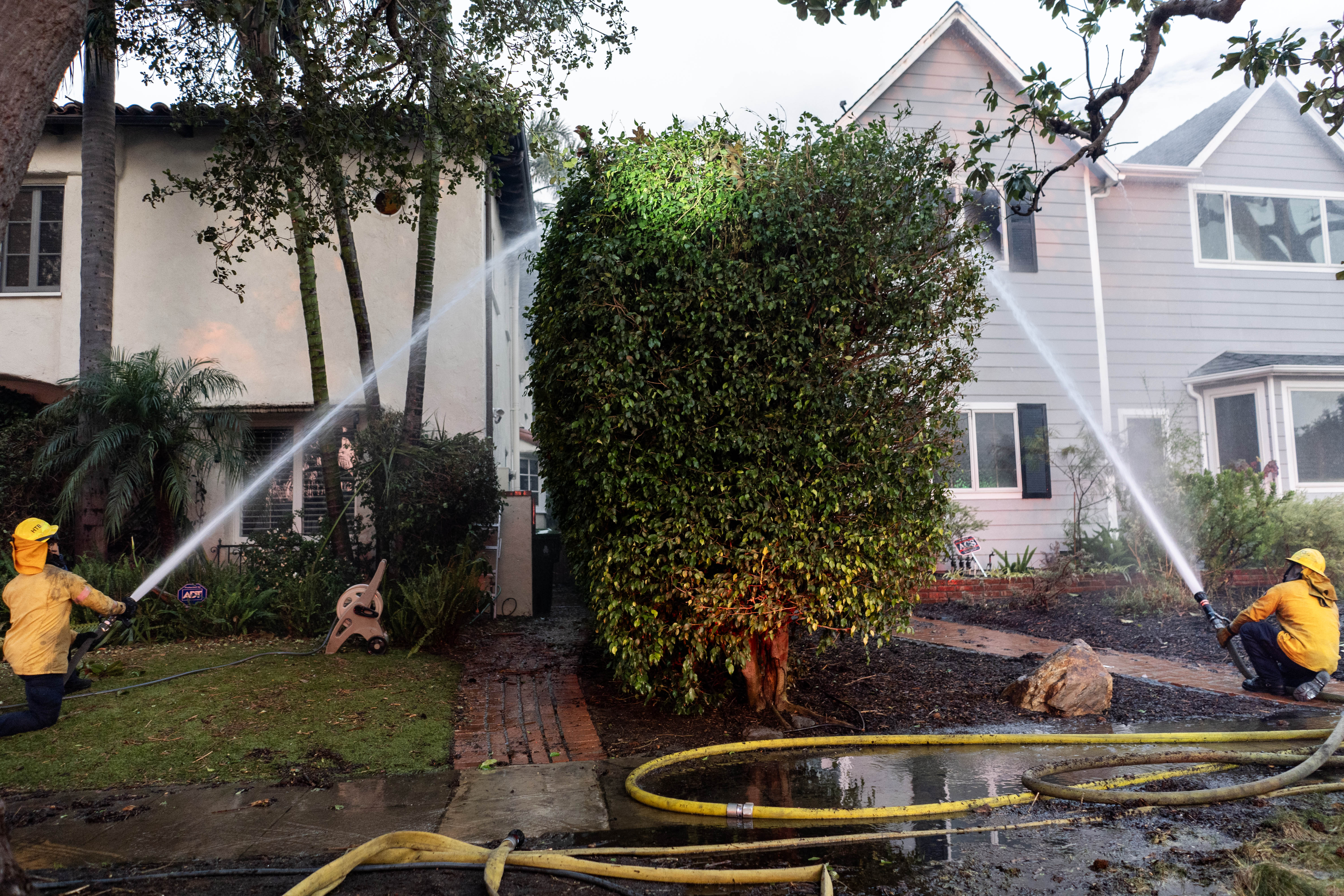 Orange County and Los Angeles County firefighters work to save homes in Pacific Palisades on Thursday. Photo / Melina Mara, the Washington Post