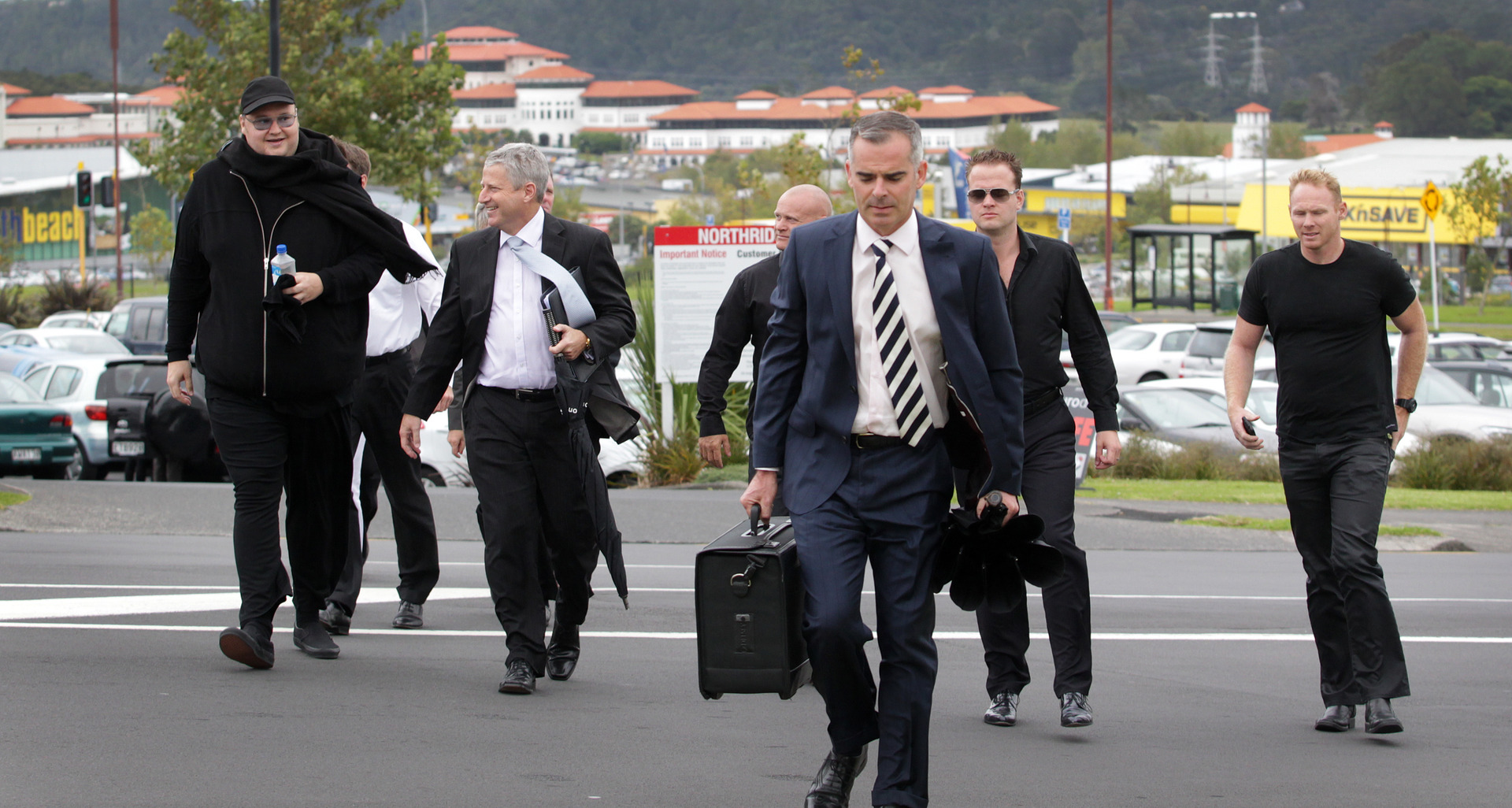 Kim Dotcom (left) arriving at the North Shore District Court in 2012 with his contingent of lawyers, co-accused and bodyguards. Photo / Sarah Ivey