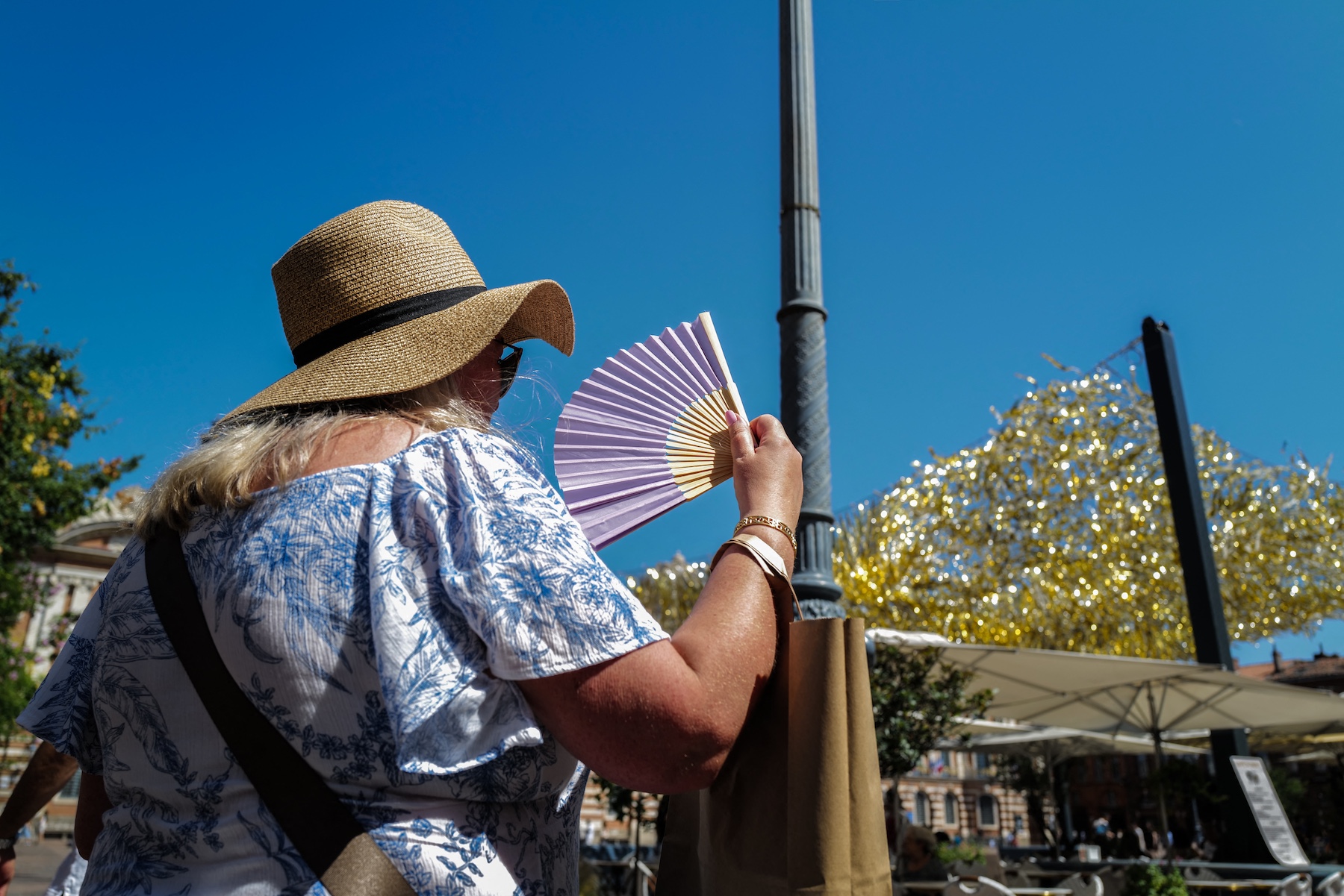 A person holds a fan due to the intense heat and heatwave on the Place du Capitole in Toulouse, France, in August. Photo / AFP