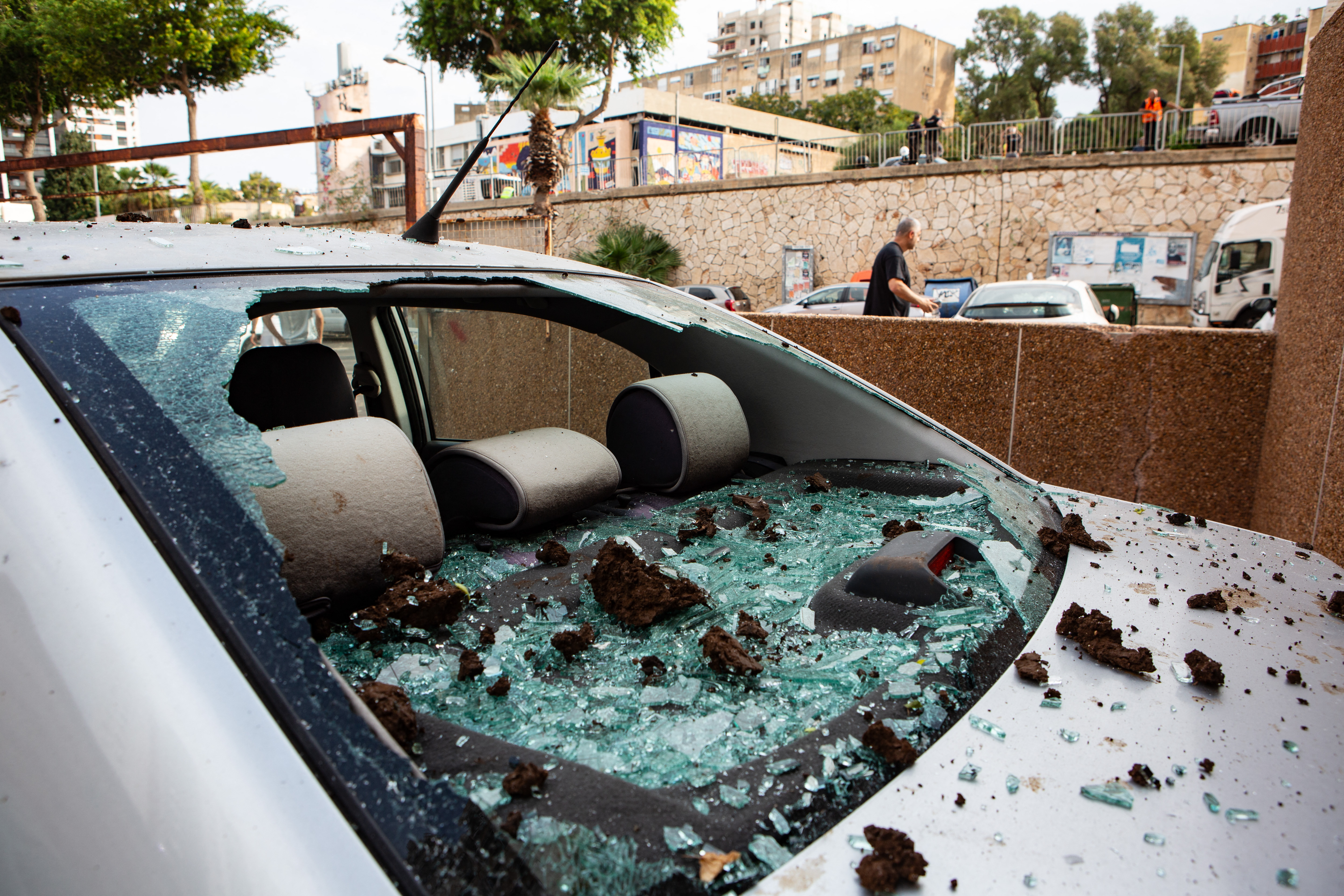 Residents and Israeli authorities in Haifa inspect the damage after an overnight rocket attack from Lebanon. Photo / AFP