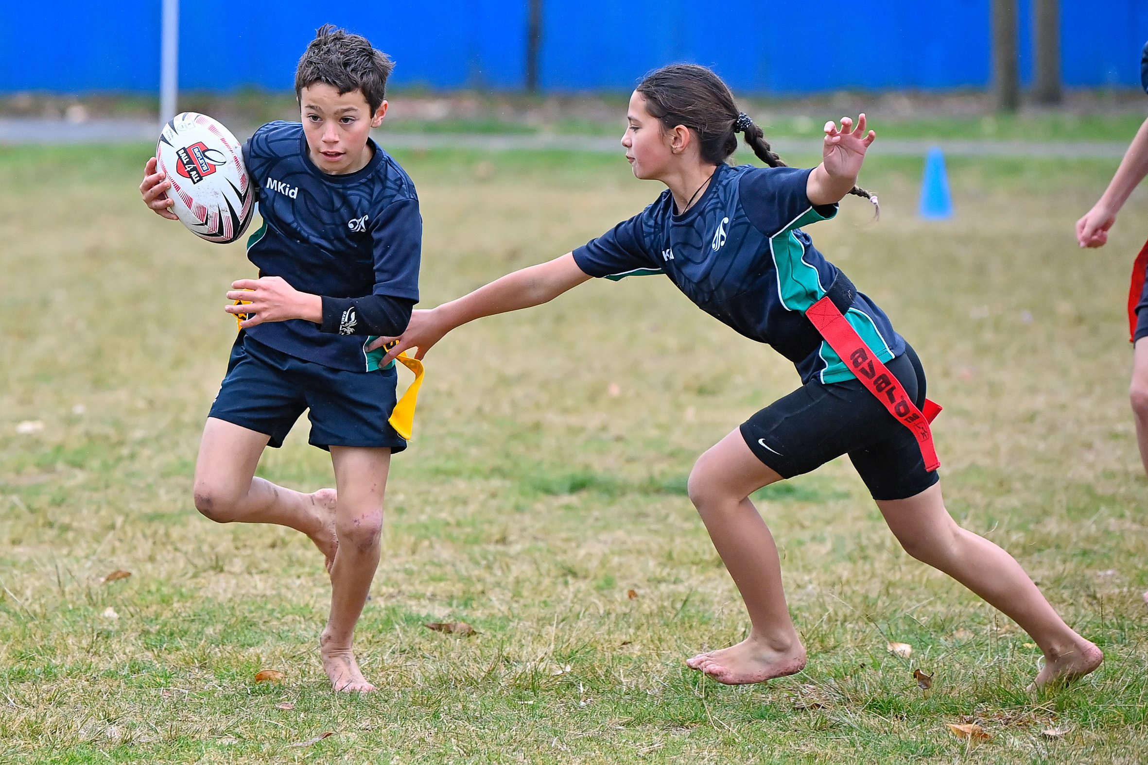 Nikau Leach tries to elude the reach of Ava Kingi Te Purei in a Rippa Rugby game reffed by former Mangapapa student and now rugby star Renee Holmes.
Photo / Paul Rickard