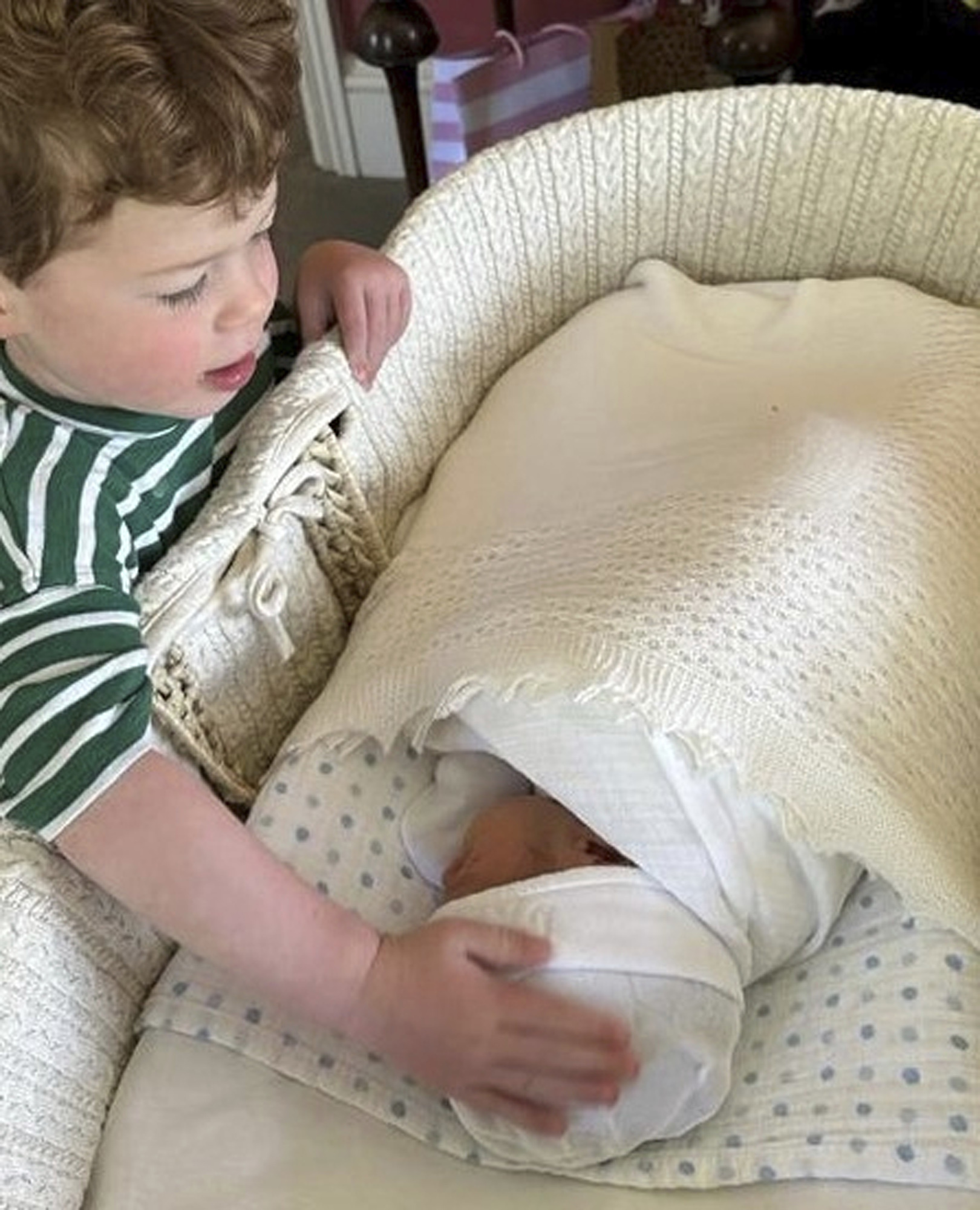 August Brooksbank touches the head of his brother Ernest George Ronnie Brooksbank. Photo / Princess Eugenie, Buckingham Palace via AP
