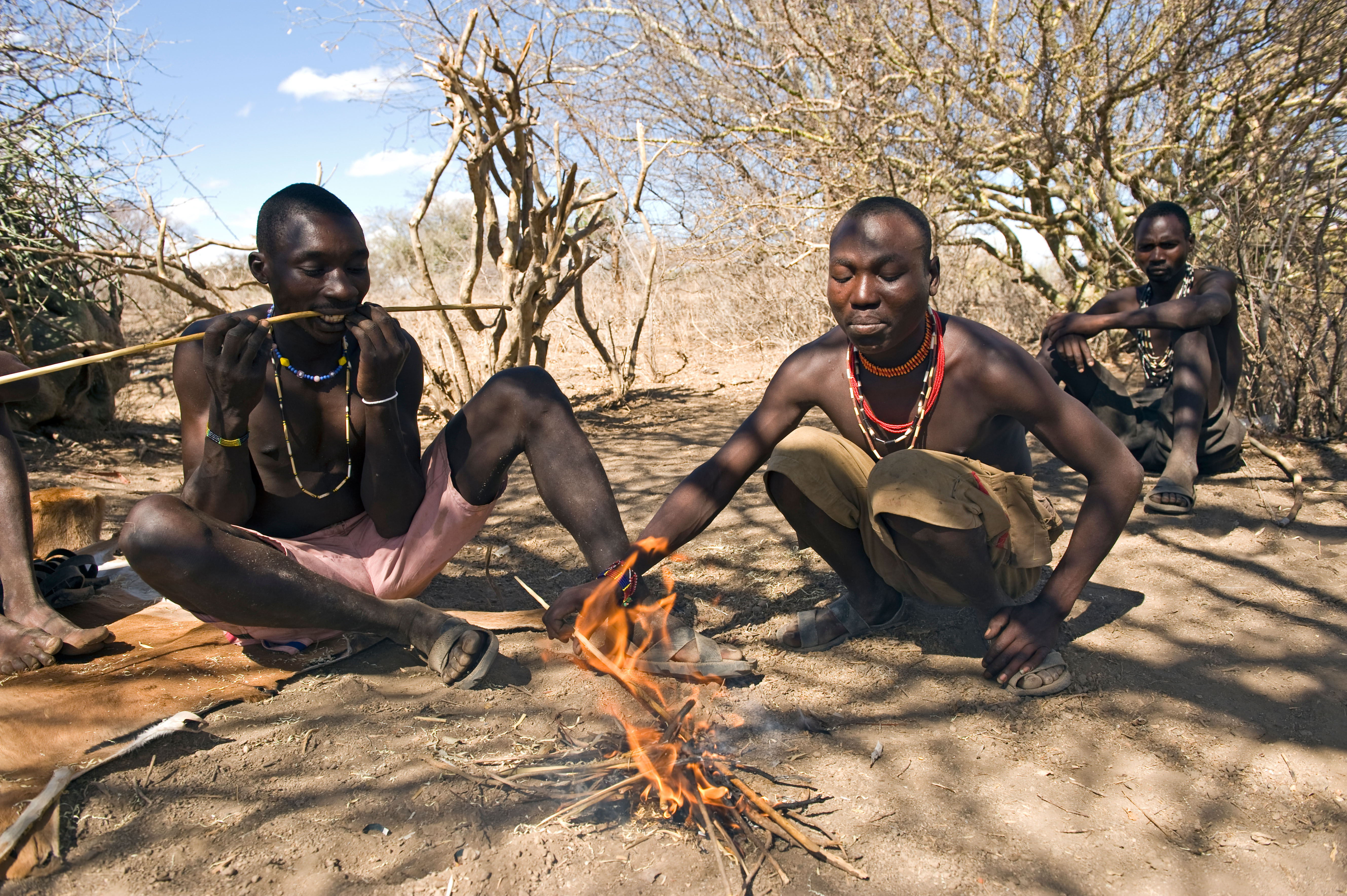 Conserving energy: Hadza hunter-gatherers rest when they can, as finding food requires effort. Photo / Alamy
