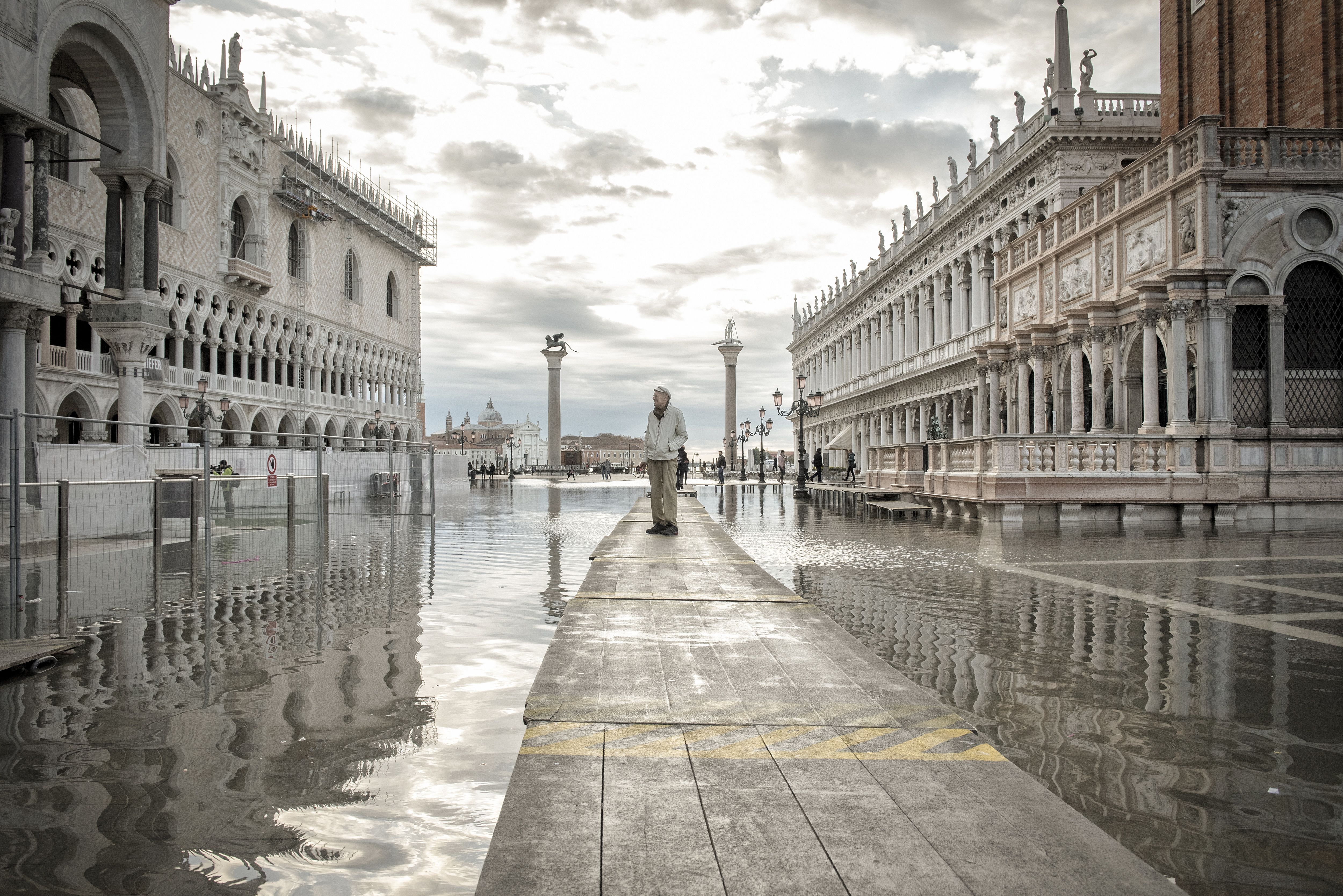 A tourist navigates flood water on St. Mark's Square in Venice. Photo / Laetitia Vancon, The New York Times
